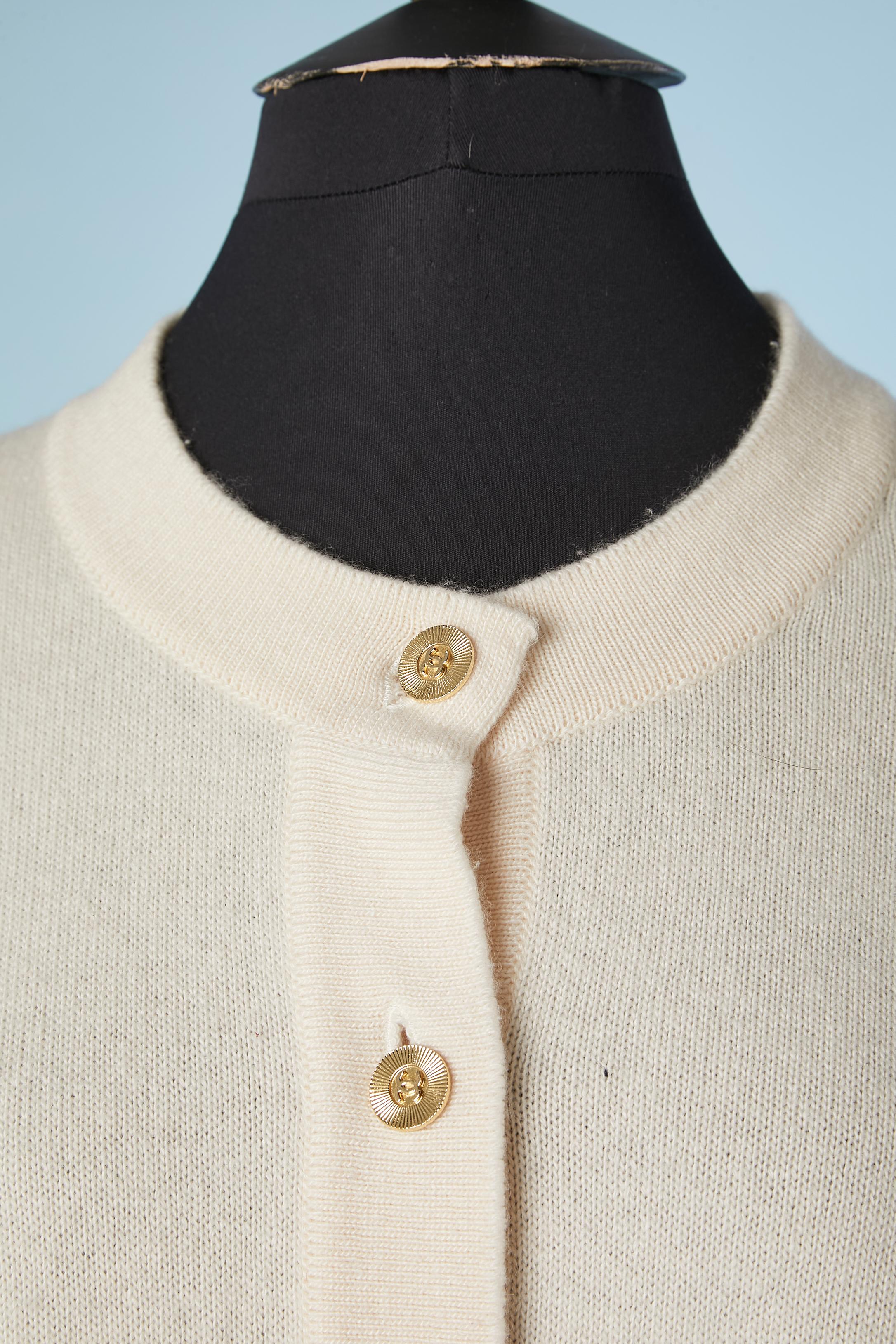 Ivory cape-cardigan in cashmere with branded gold metal buttons. Lenght in the middle front= 85 cm 
Lenght on the side = 65 cm 
Size : from M to XL 