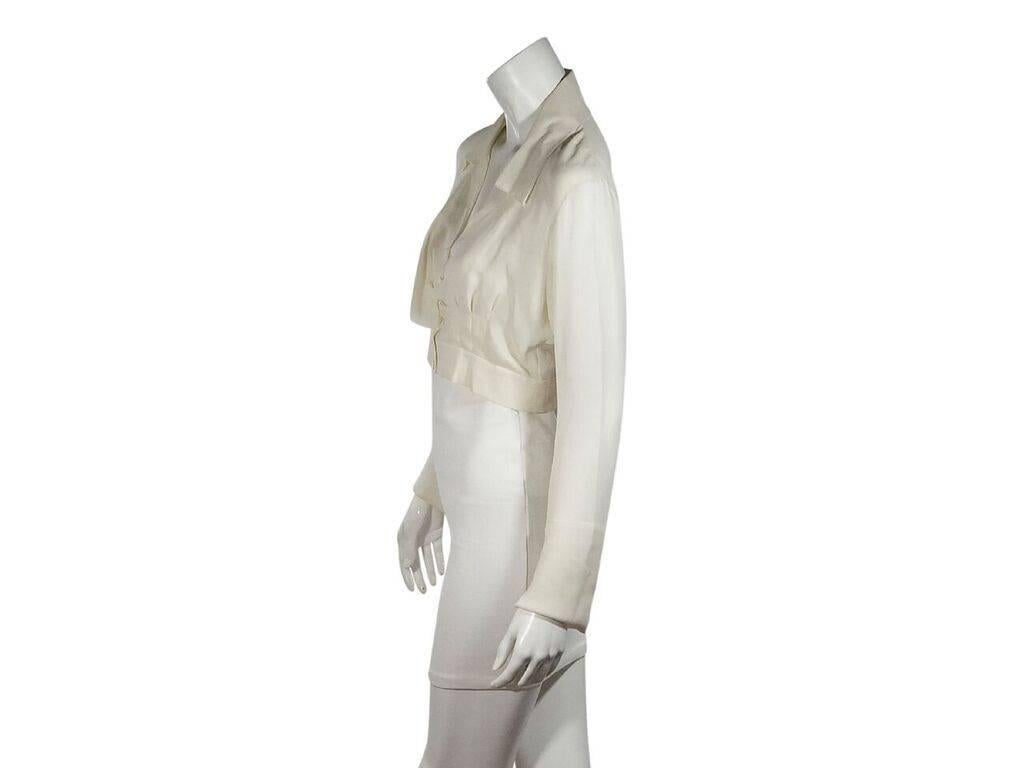 Product details:  Ivory silk cropped blouse by Chanel.  Spread collar.  V-neck.  Long sleeves.  Button-front closure.  Draped-bodice detail.  Banded hem.  Label size FR 38.  34