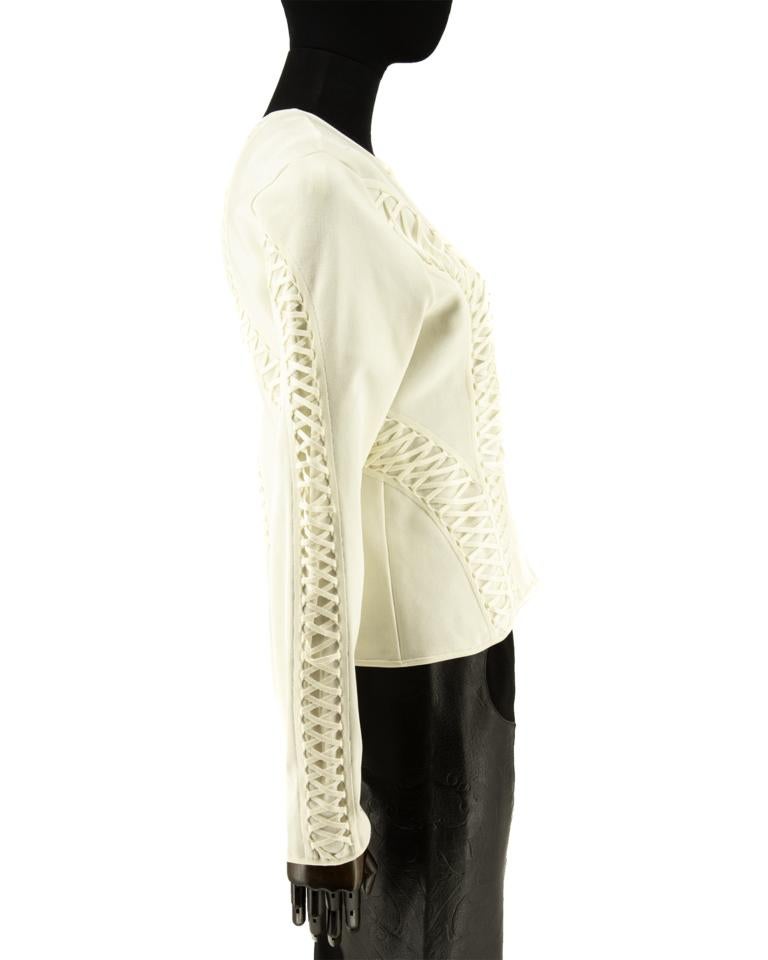 Christian Dior ivory knitted jacket with lace details going from front to back and also down the sleeves in a complimenting knit technique. Fastening down the centre front with knitted rouleau loops and mother of pearl buttons.

Christian Dior