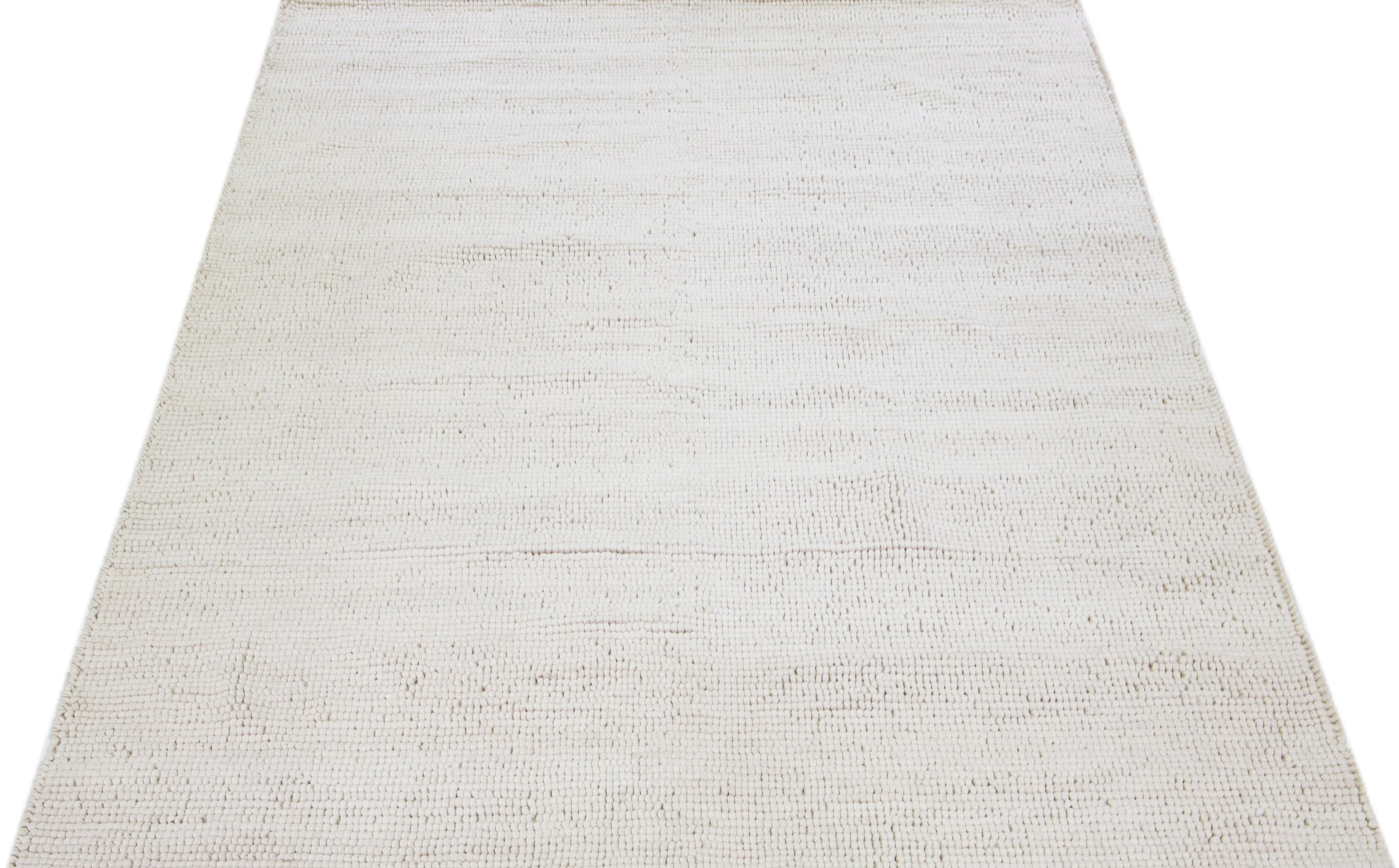 This beautiful Felt hand-woven wool rug is part of our Westport Collection with a natural Ivory color field and features an all-over pebble design.

This rug measures: 10' x 14'.

Custom colors and sizes are available upon request.

