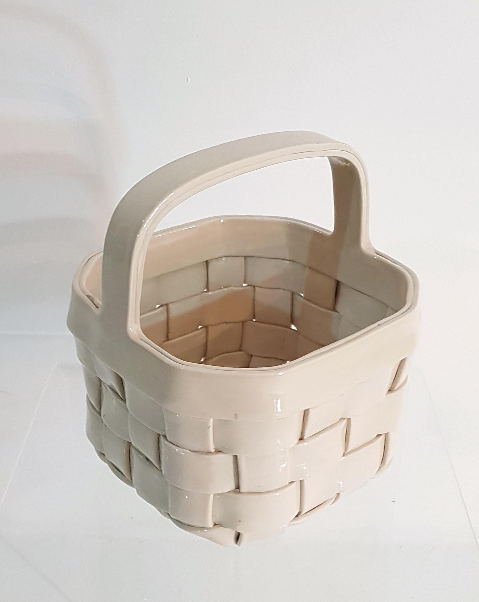 Hand and made basket in ceramic in ivory. Marked underneath 