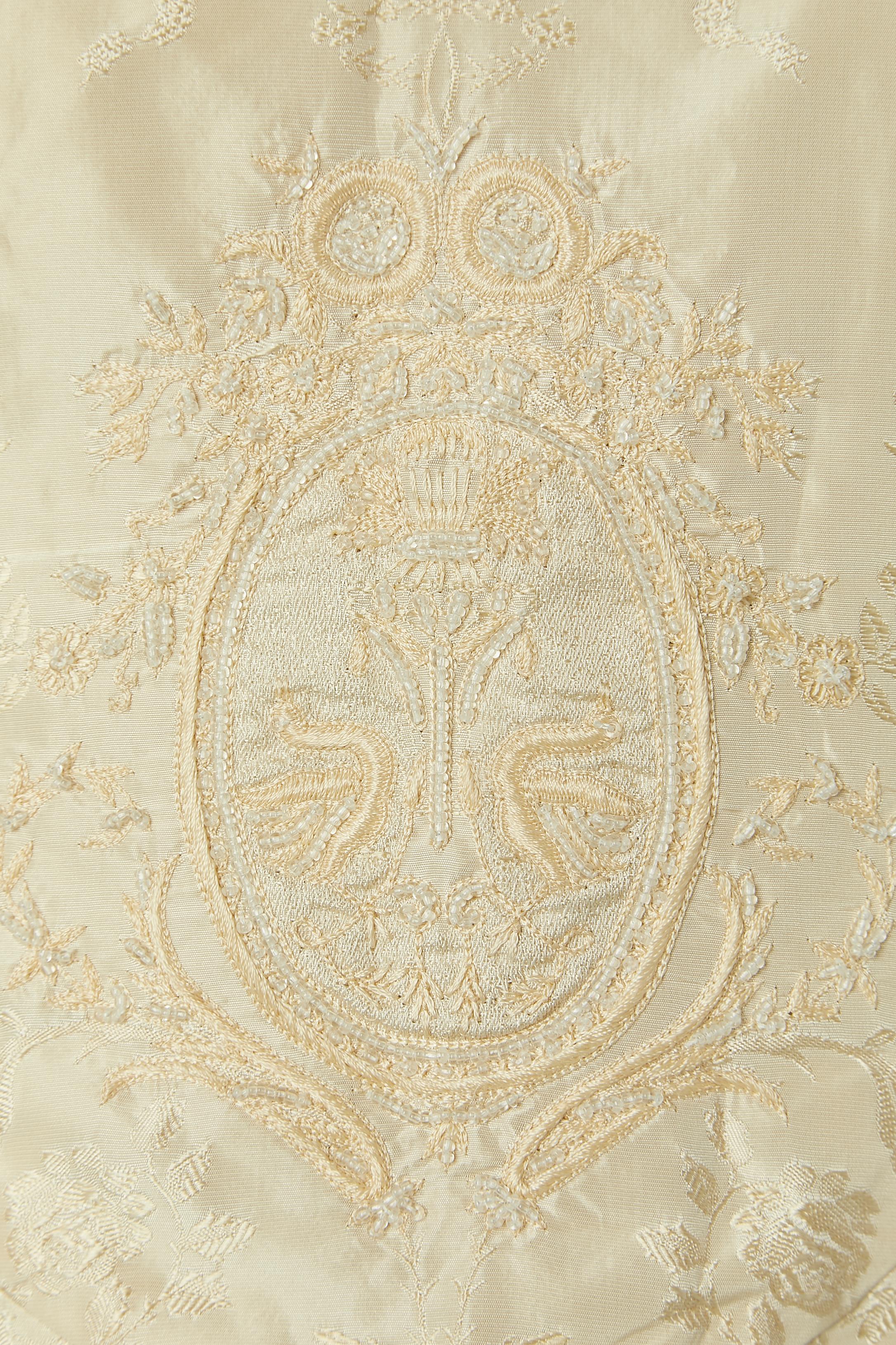 Ivory damask evening dress with beadwork . Shell fabric composition: 100% silk. Polyester lining. 
Invisible zip closure on the middle back + 2 buttons and buttonhole ( one on the waist, one on the top middle) Gather on the back and 
