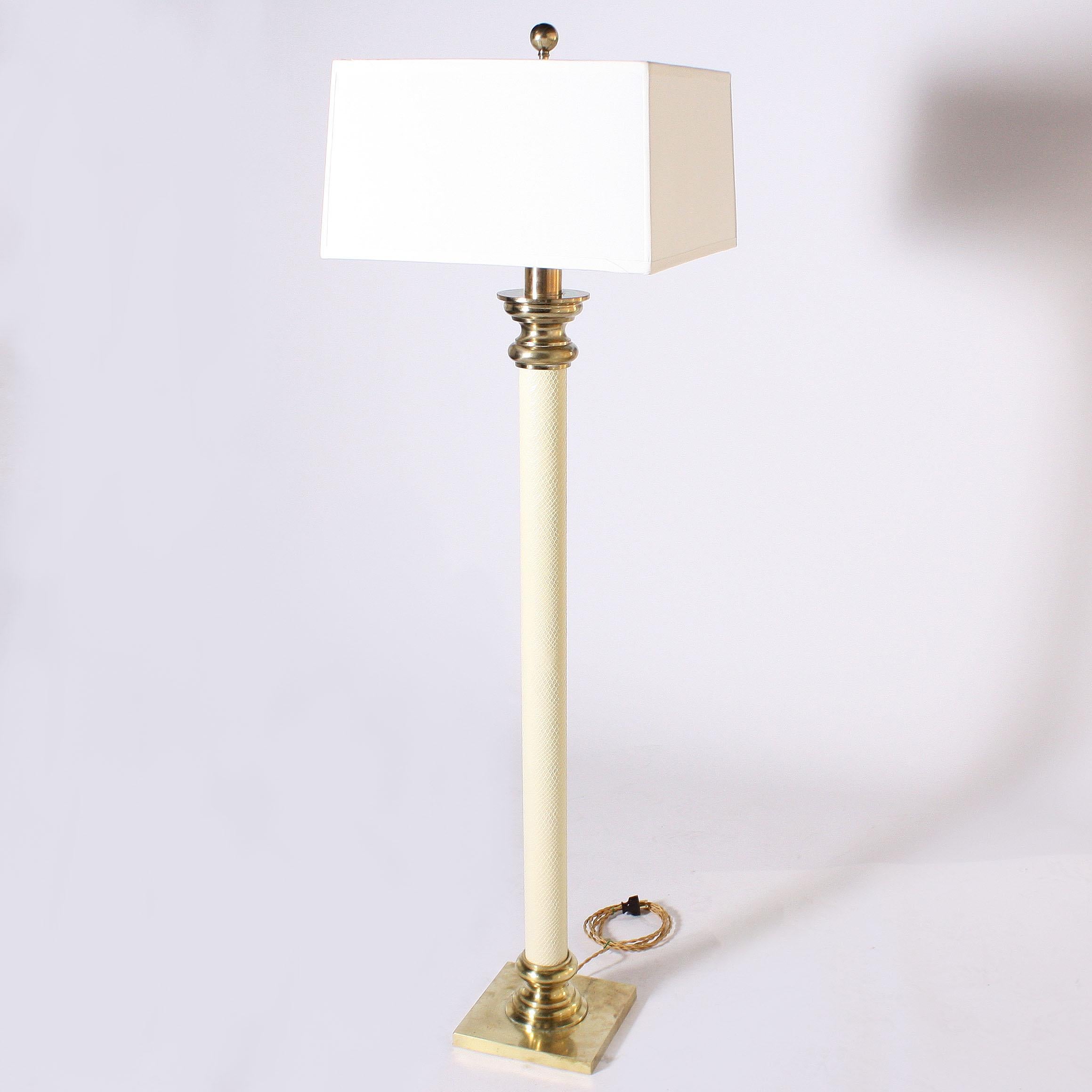 Ivory faux leather floor lamp with brass details, circa 1970.