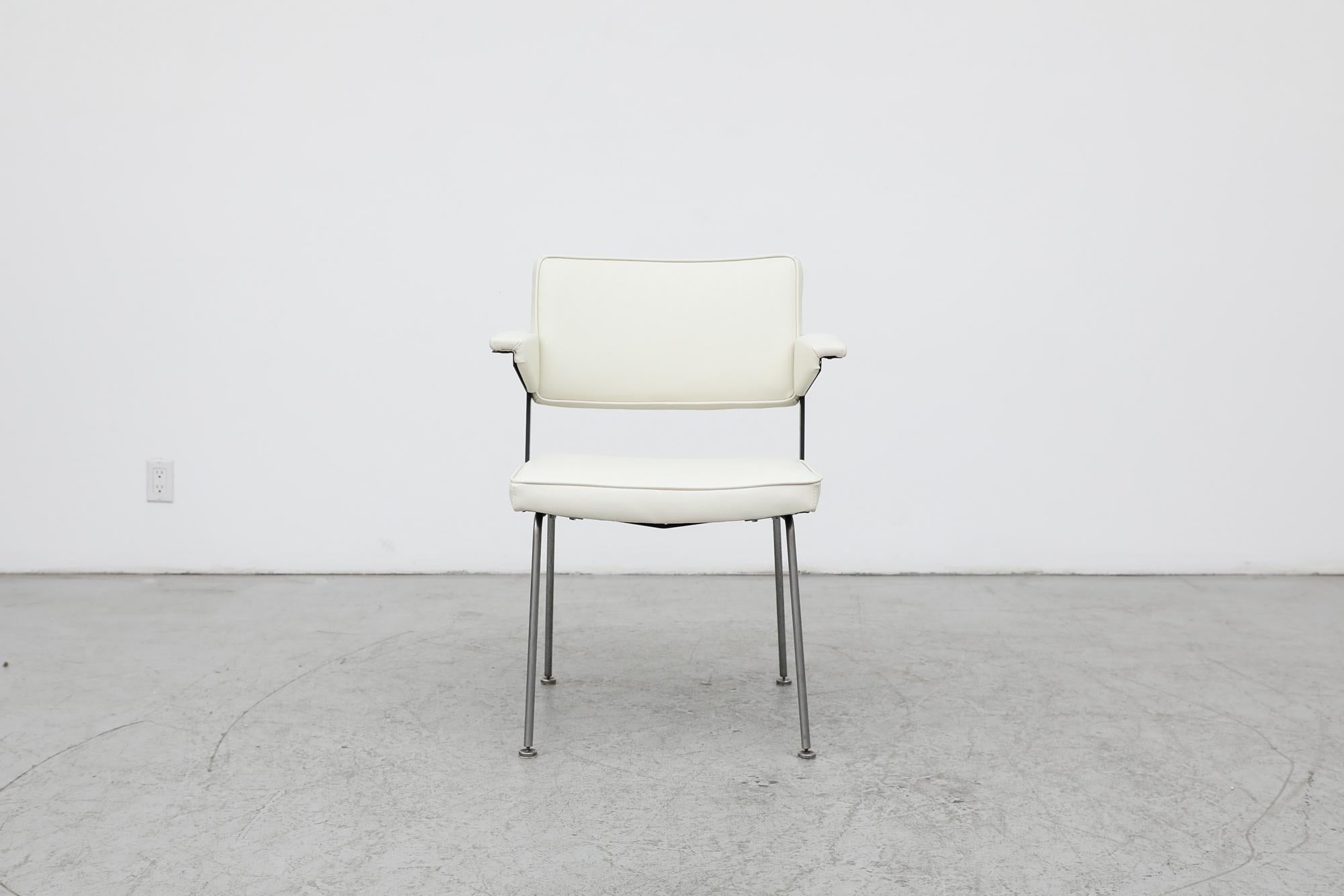 Gispen No.11 armchair with new ivory vintage vinyl upholstery on a wide body frame. The chair has beautiful Prouve style armrests on a black enameled metal frame with tubular brushed steel legs. In otherwise original condition with wear consistent