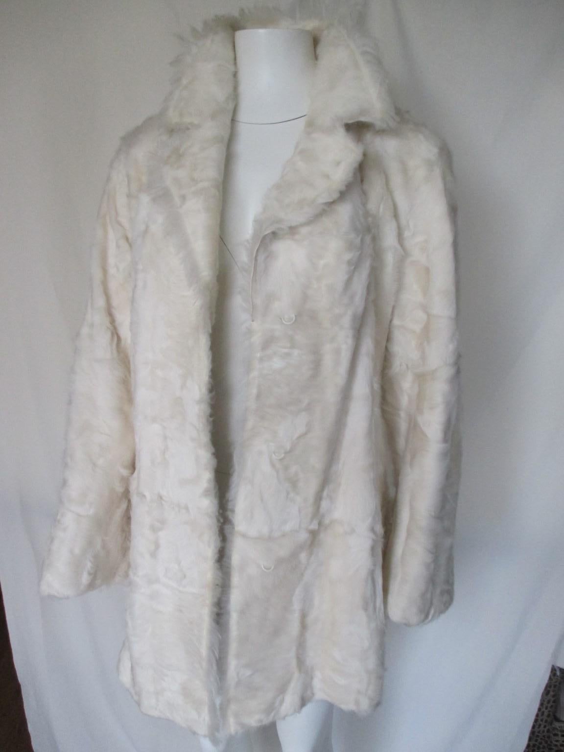This exclusive vintage model is made of the finest naturel goat fur.

We offer more luxury fur items, view our frontstore.

Details:
Color: Ivory white
With 2 lined pockets and 3 closing hooks.
Fully lined
This fur is soft, shiny, supple and very