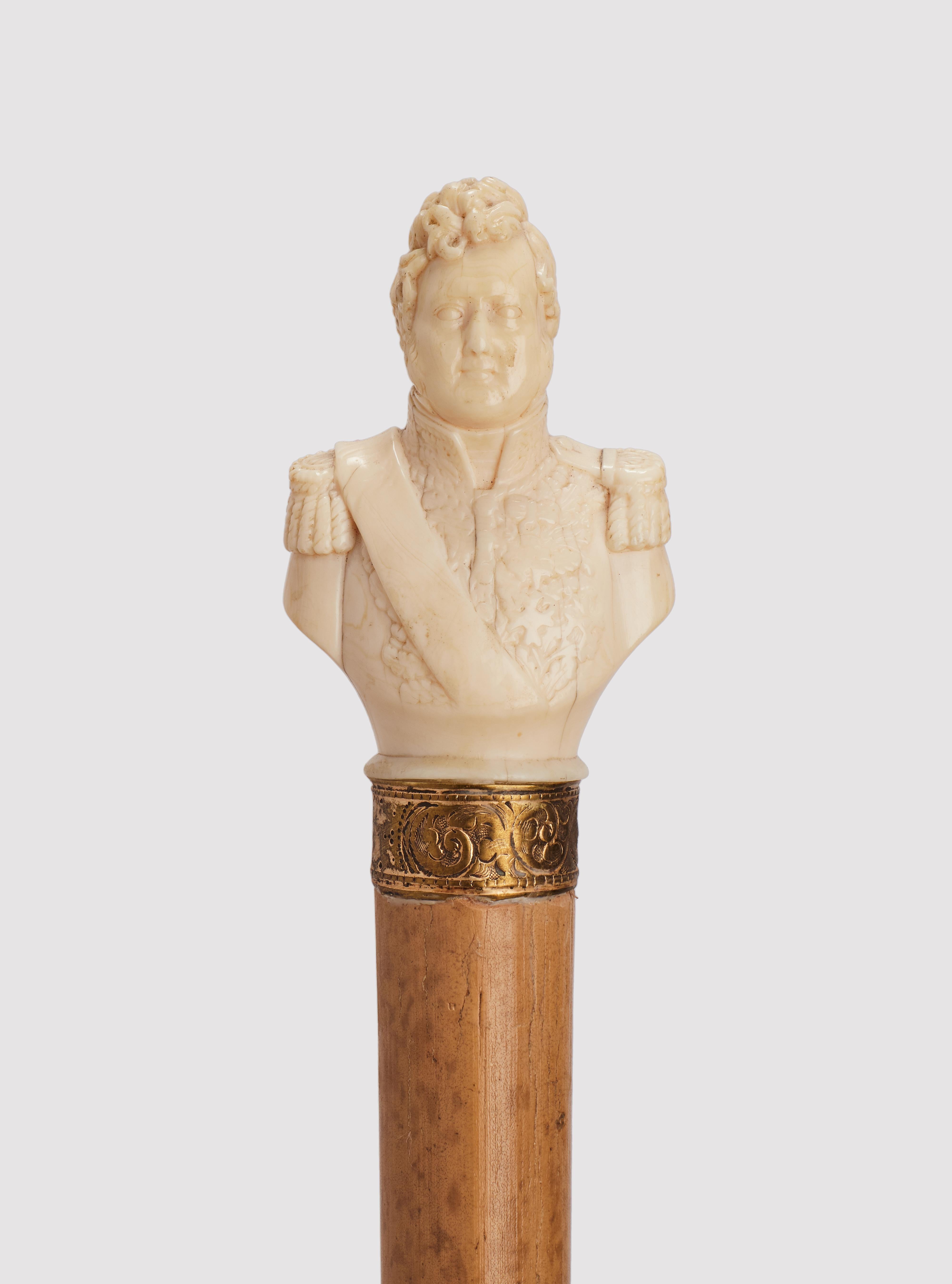 Canne : manche en ivoire sculpté représentant un portrait raffiné de Louis Philippe, roi de France. Arbre en bois de Malacca. Bague gravée en argent doré. Virole en métal. France vers 1870.                                                            