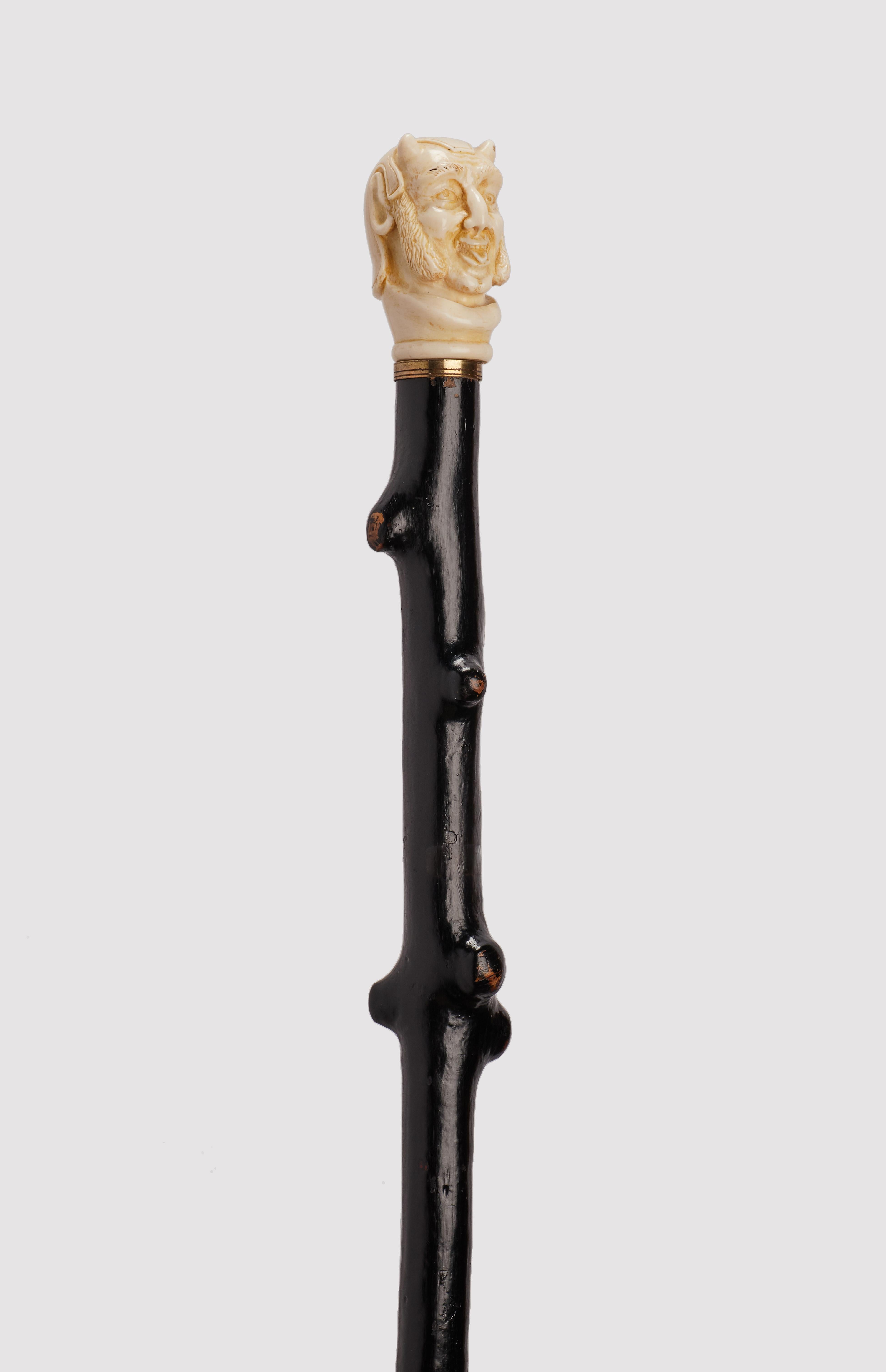English Ivory handle walking stick depicting Mephistopheles face, England 1870. For Sale