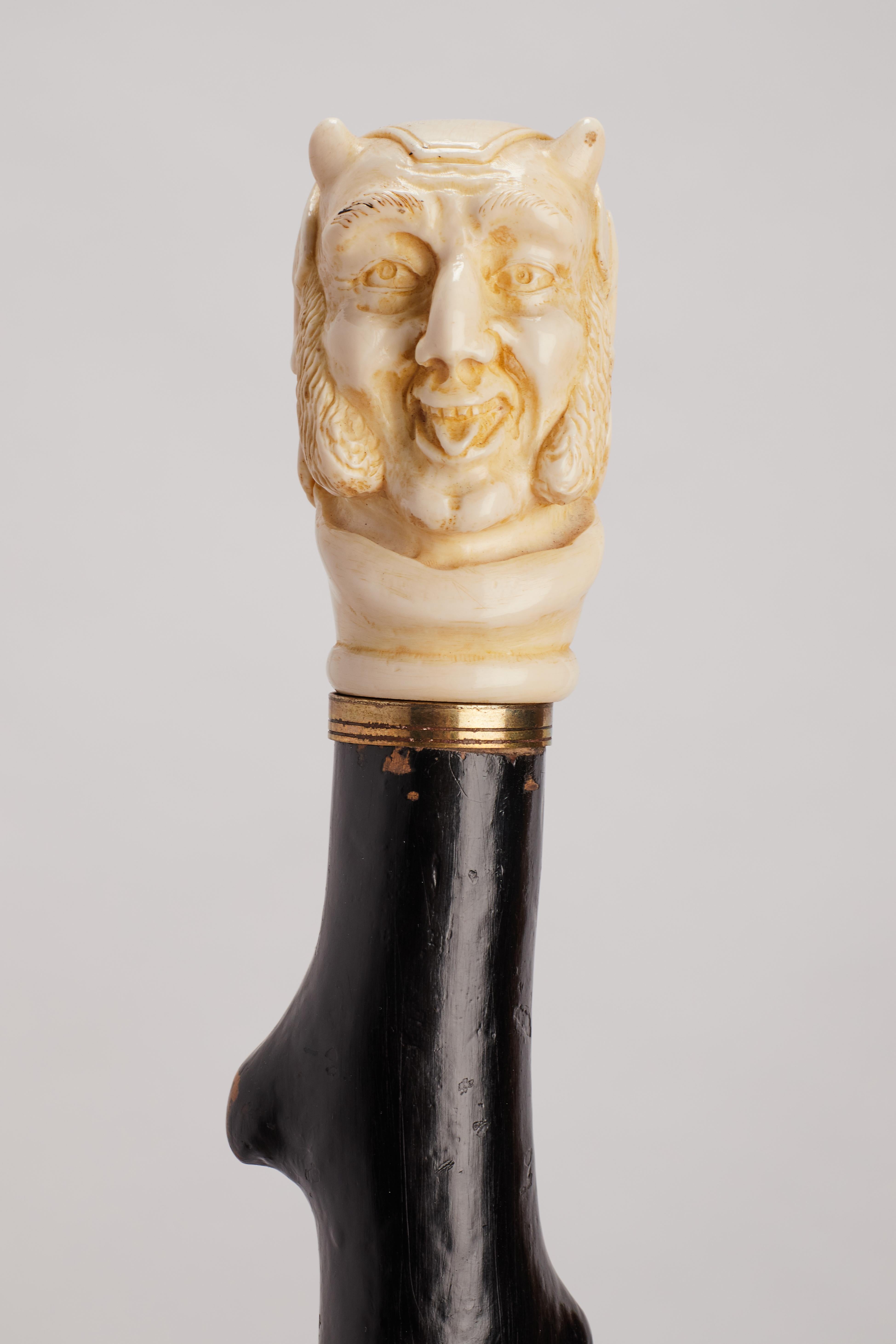 19th Century Ivory handle walking stick depicting Mephistopheles face, England 1870. For Sale