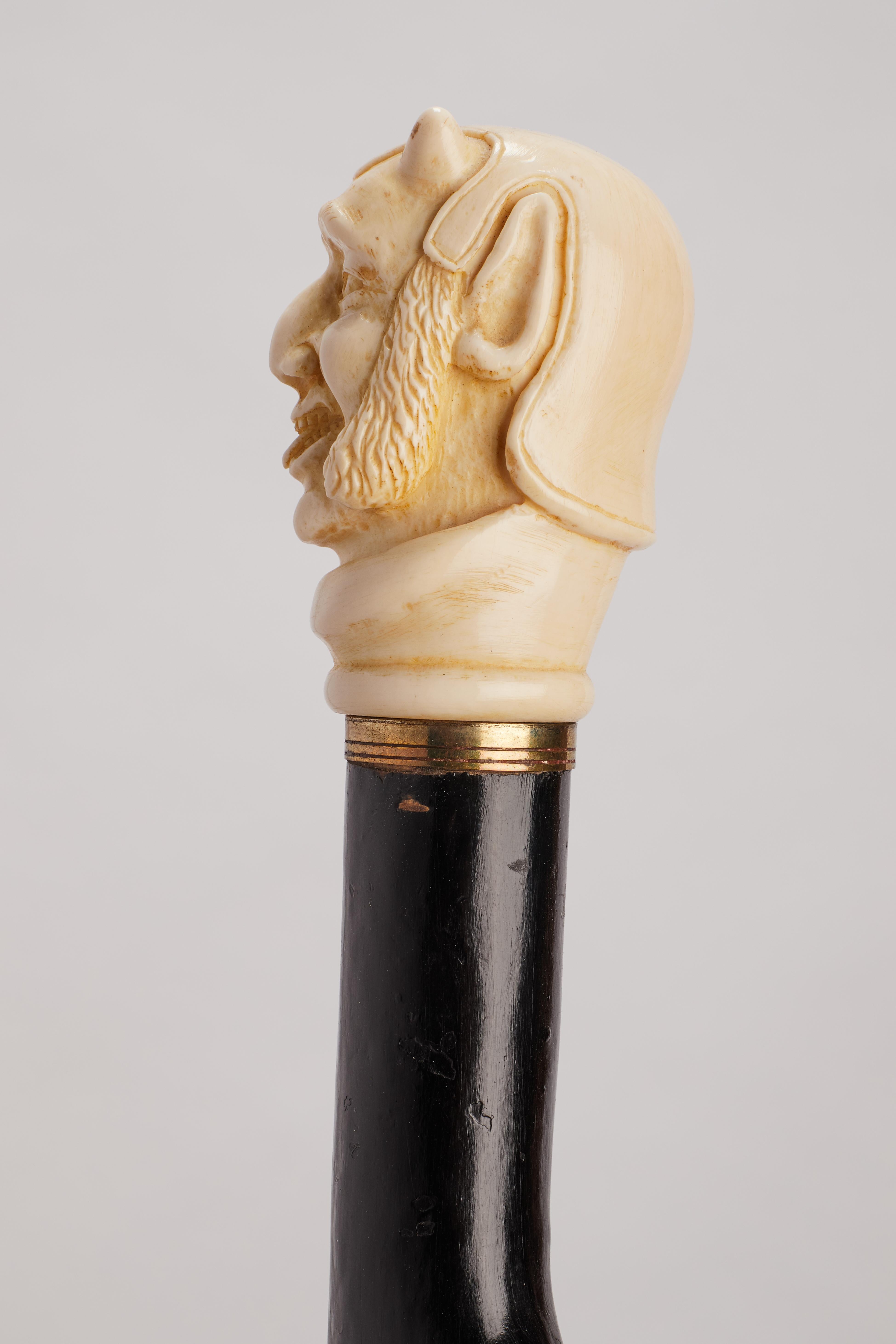 Ivory handle walking stick depicting Mephistopheles face, England 1870. For Sale 1