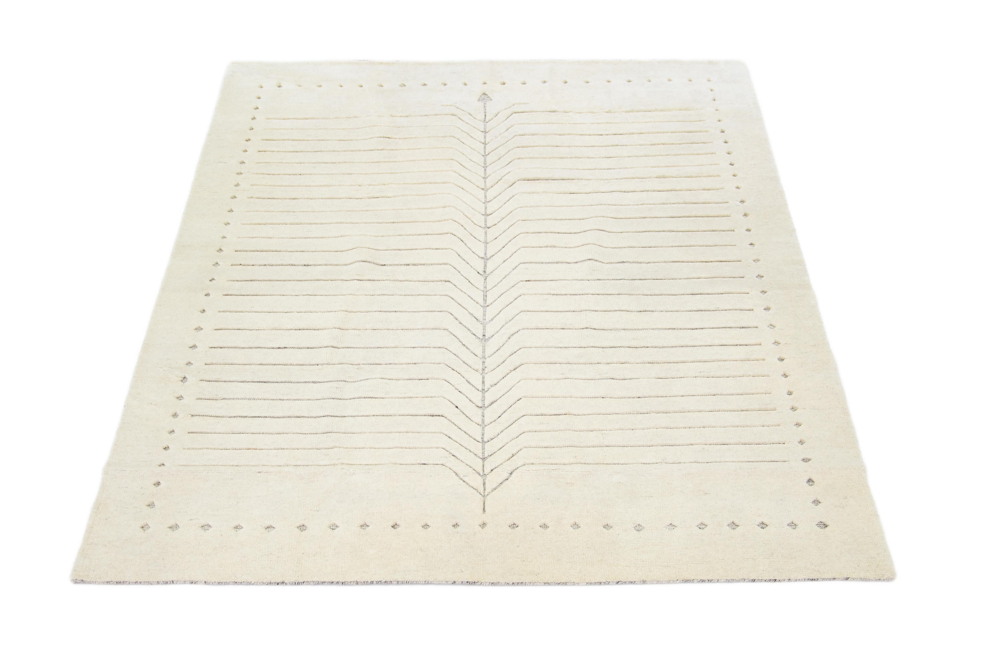 Exquisitely crafted by hand, this modern Moroccan rug features a luxuriously minimalist gray design in the most elegant ivories.

This rug measures 8' x 10'.