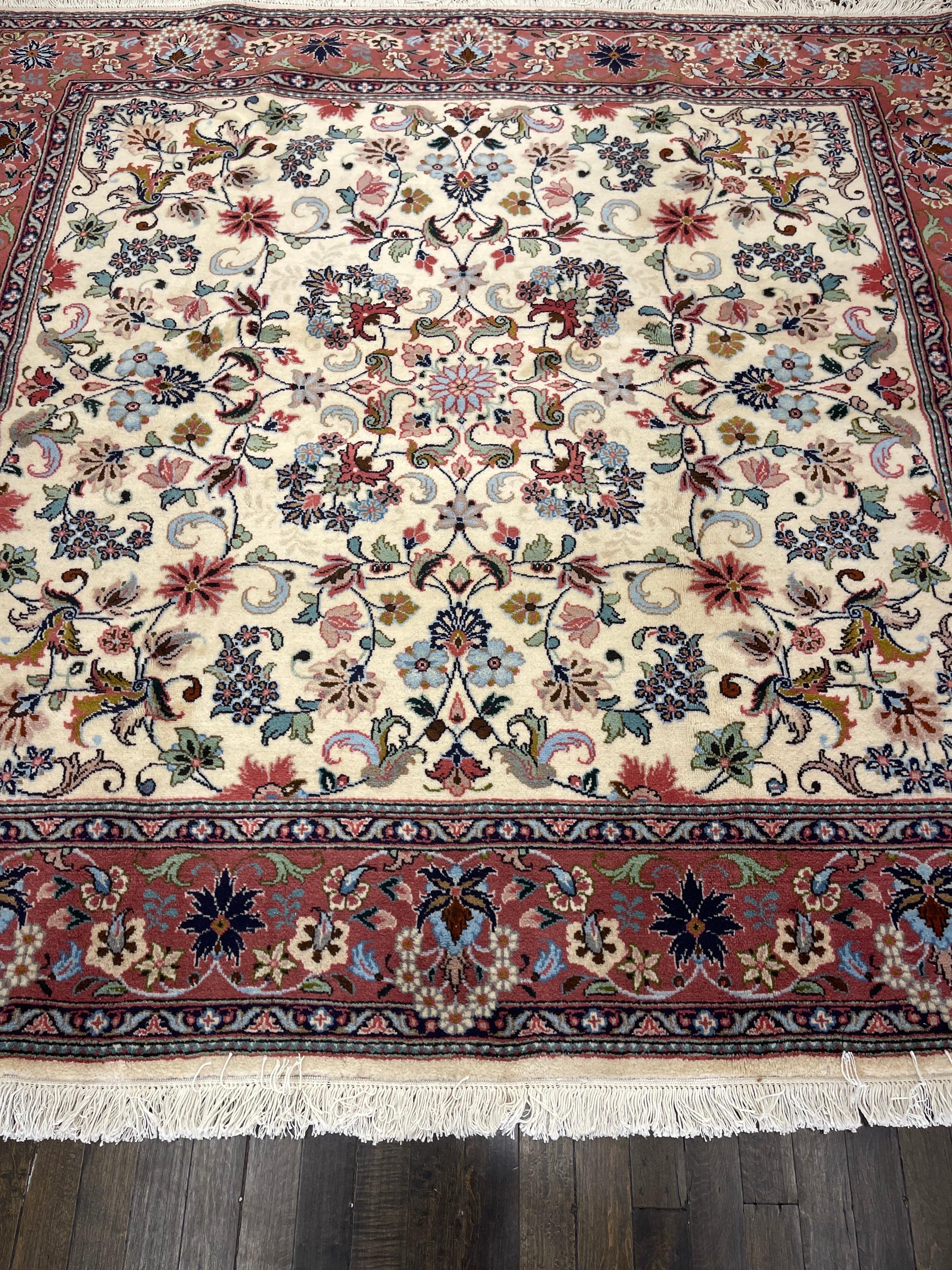 Beautiful hand woven rug made in one of the rug making centers in Iran, this Kashan features an ivory field decorated with flowers and leaves surrounded by a floral peach color border. The radiant colors like dark and light green,indigo and sky