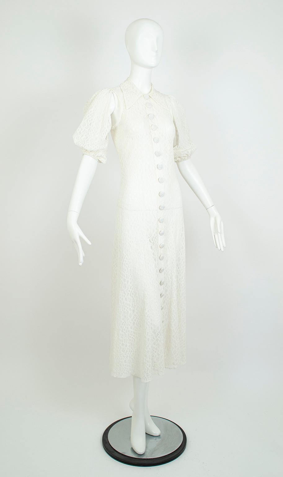A wedding gown that bridges centuries, this unusual dress combines Medieval slashed sleeves with the sensuality of a liquid 1930s gown and finishes with a sensible button-front collared shirtwaist bodice. Devoid of stiffness, this gown permits airy