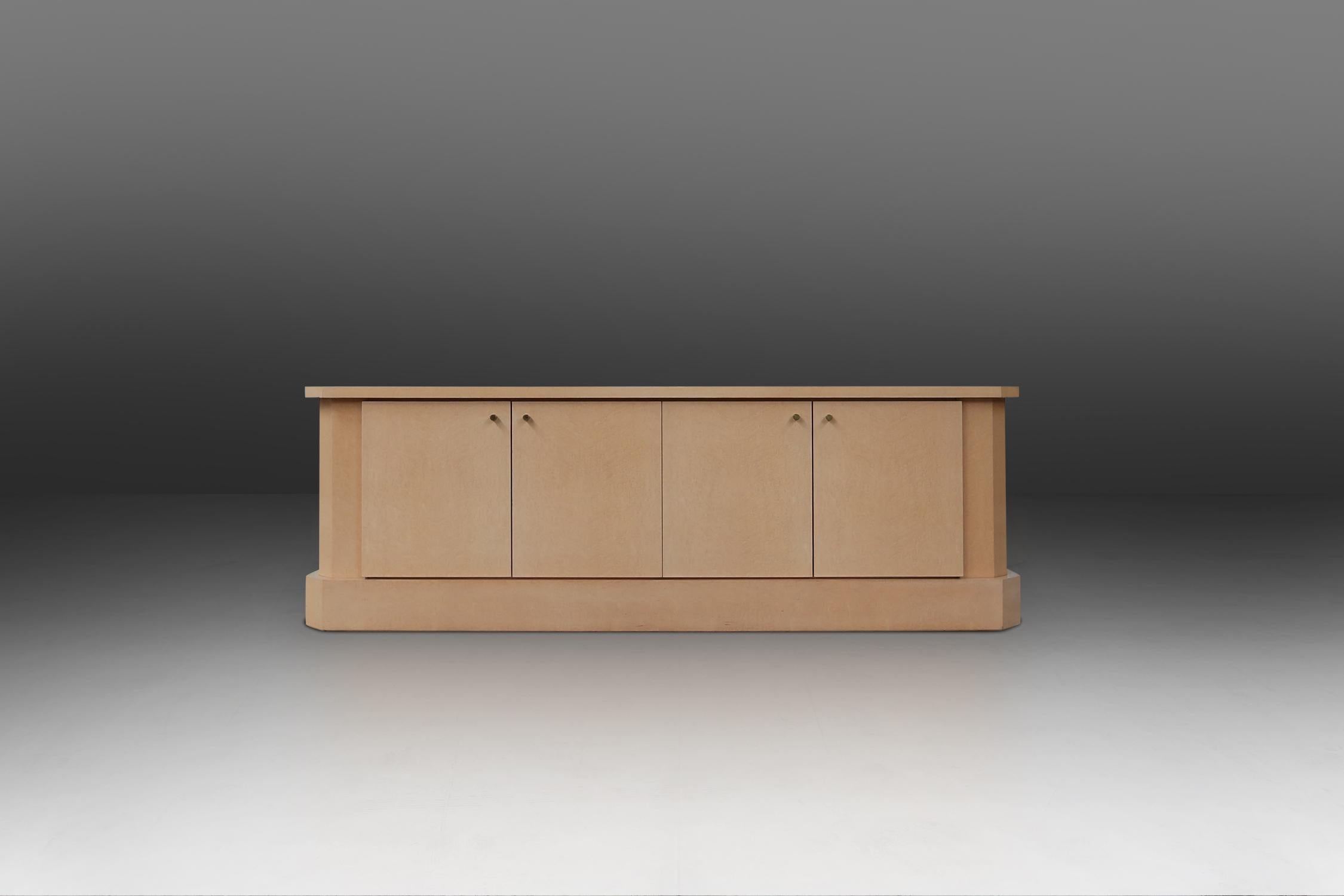 High quality sideboard by Belgian designer Jean Claude Dresse.
Made of burl wood with ivory lacquer. The 4 doors has brass pulls.
Interior with adjustable shelves.