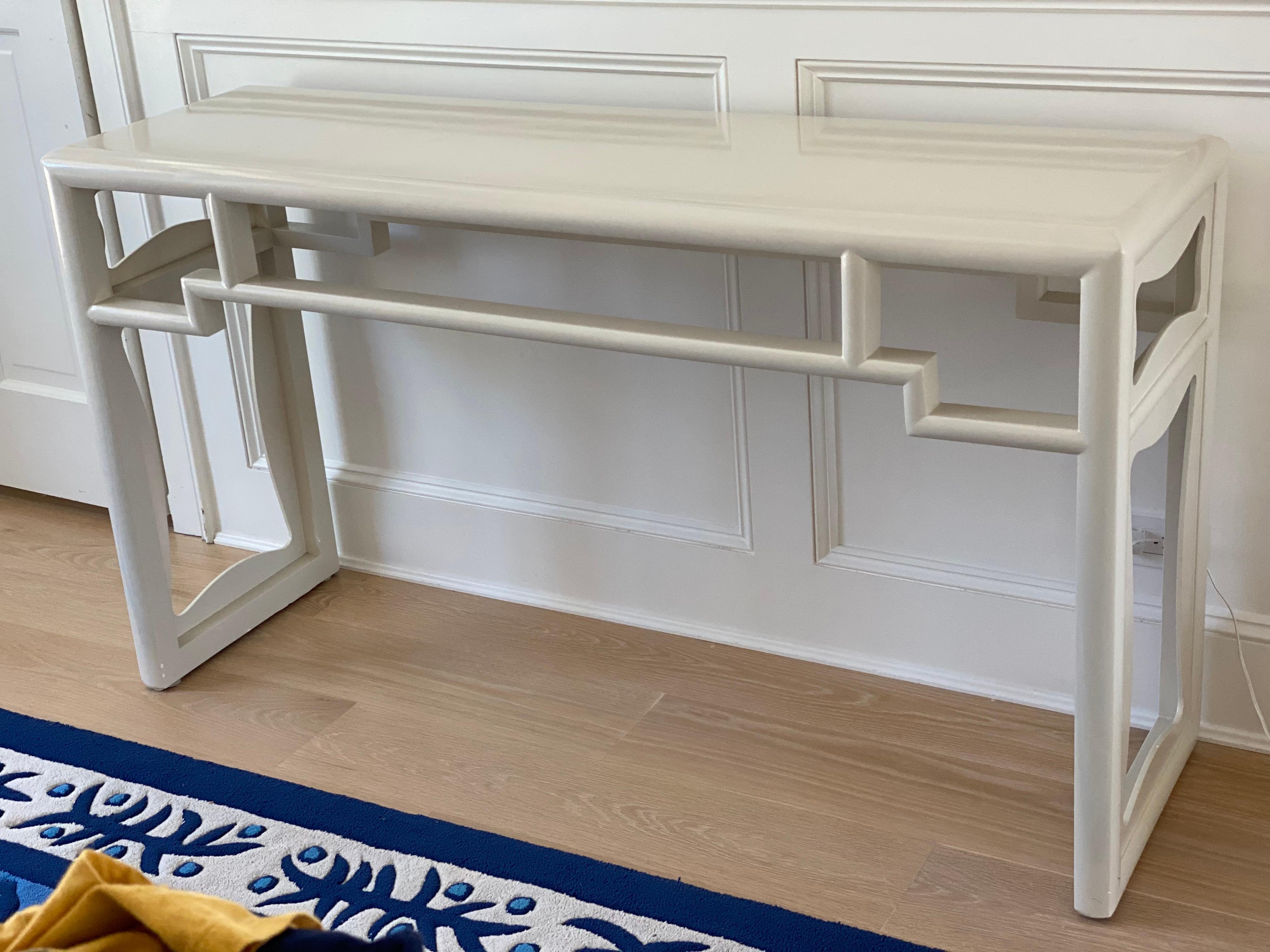 Ivory lacquered Chinese Chippendale style console table
One Knick on side rail otherwise very good condition. Light wear to the top.
Measures: 54