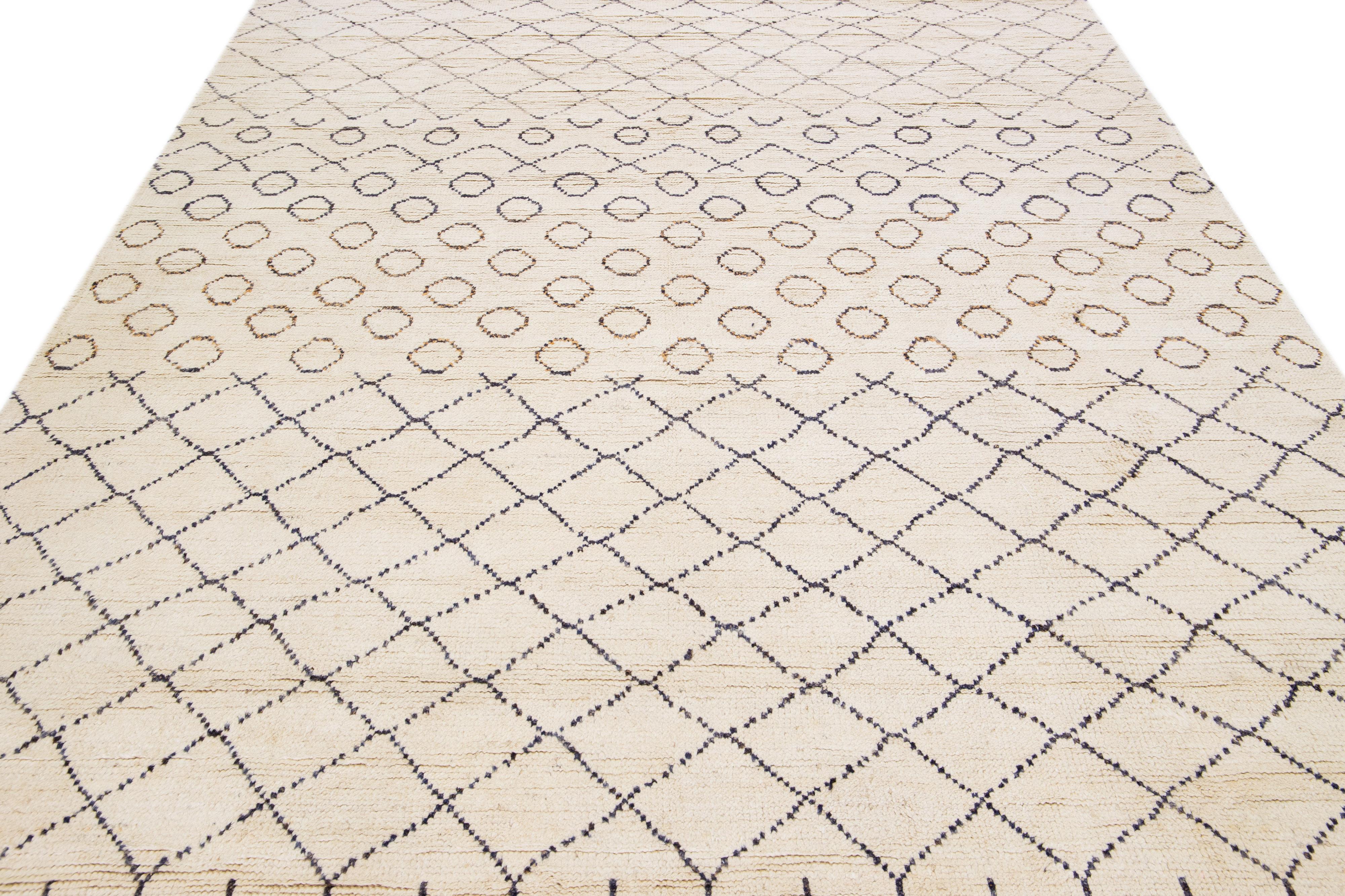 Beautiful modern Moroccan-style hand-knotted wool rug with an ivory field. This piece has orange and blue accent colors in a gorgeous geometric design with fringes on the top and bottom end.

This rug measures: 8'1
