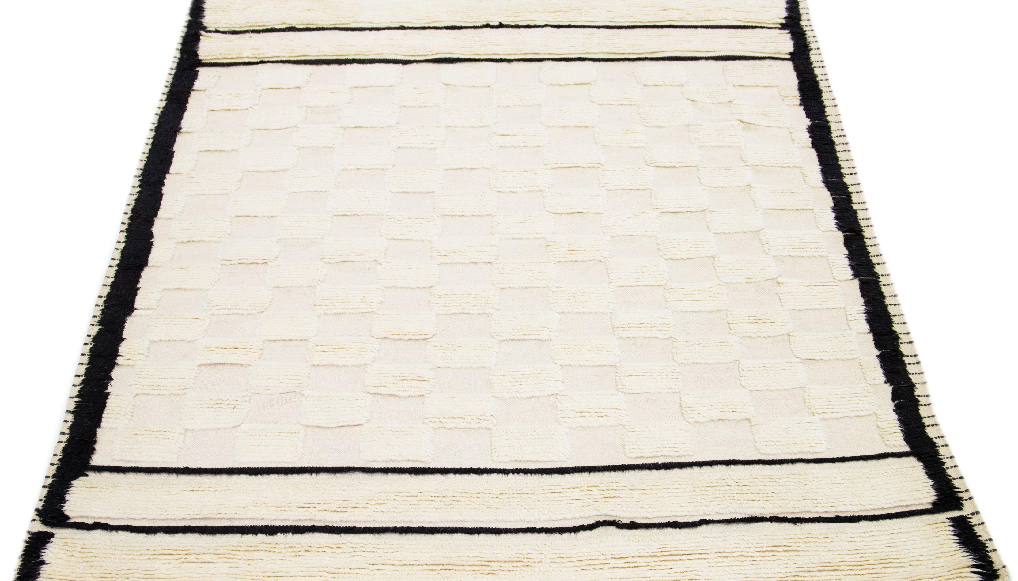 This Modern rug features a subtle background and perfectly complements the carefully handcrafted wool rug adorned with a stunning modern Moroccan design. The exquisite combination of soft ivory colors creates a beautiful checker pattern to capture