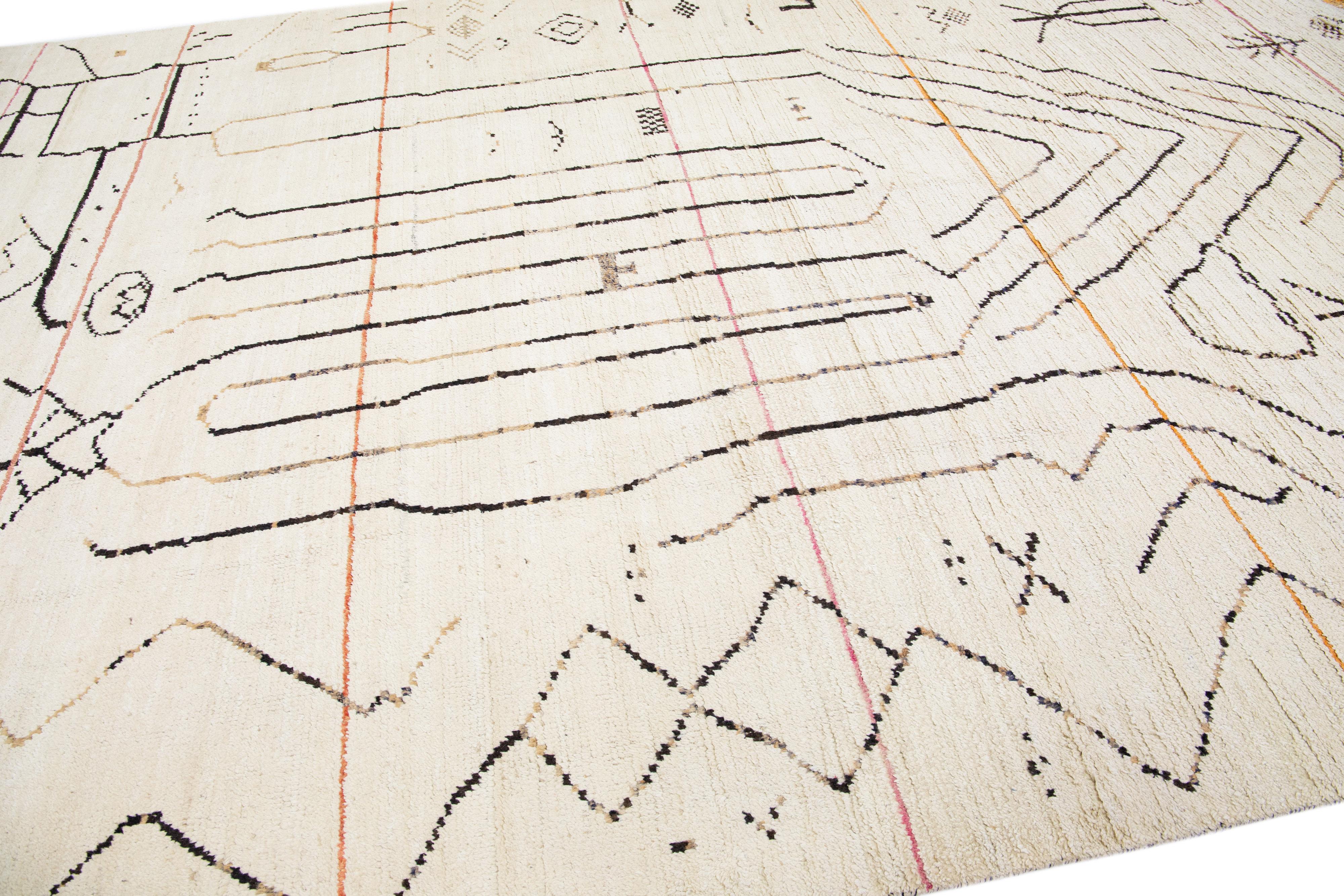 Beautiful moroccan berber style hand-knotted wool rug with an ivory field. This piece has multicolor accents in an all-over geometric abstract design.

This rug measures: 10' x 14'8