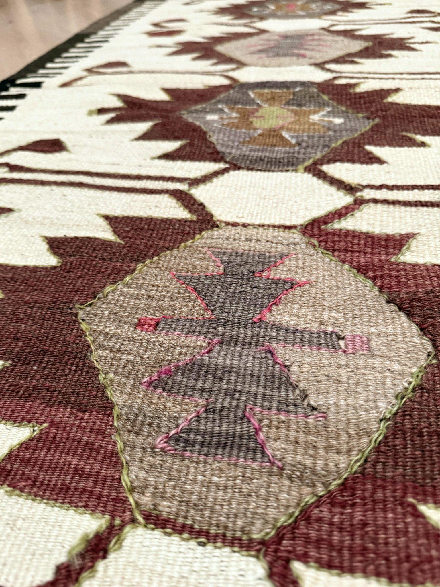 Tessuto a mano nella regione di Mut, nel sud della Turchia, questo kilim di metà secolo presenta un'audace catena di medaglioni uncinati, simile a un totem: un design accattivante spesso paragonato alla tessitura Navajo per la sua forte geometria e