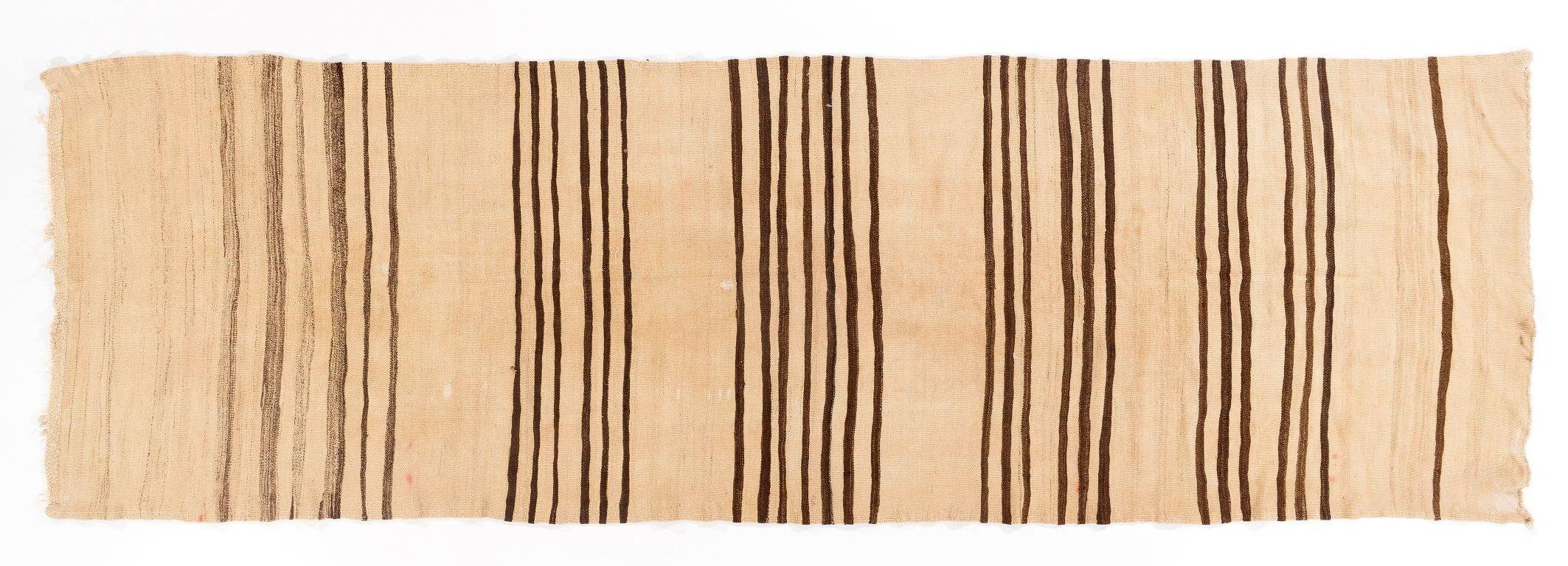 A beautiful, simple vintage flat-woven/kilim runner rug from the 1970s, woven with un-dyed natural wool in Central Turkey featuring a banded design in cream and brown. 

It is in good condition with no issues, professionally cleaned, reversible and