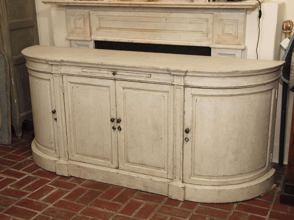 A painted oak four door buffet with curved doors on each end, and pull out shelf in center.