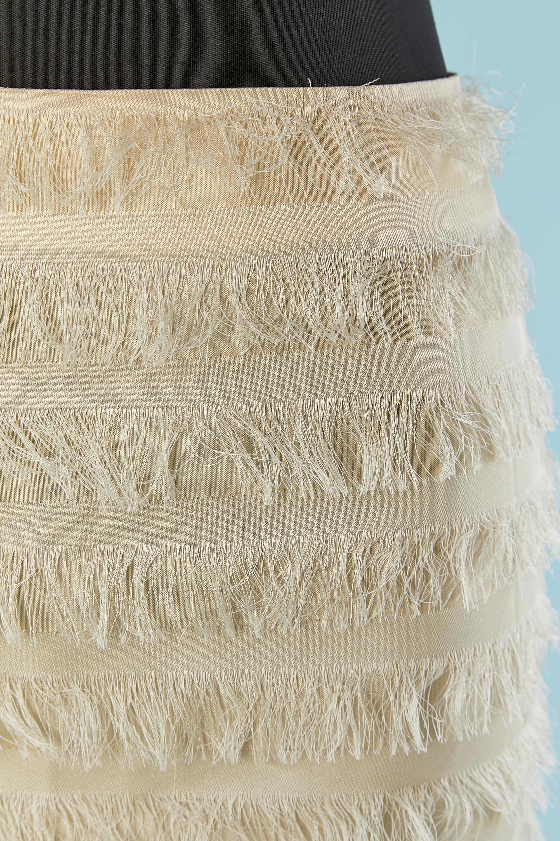 Ivory pencil skirt with thread fringes and tulle edge. No fabric tag composition but probably silk or rayon. No lining. Split in the middle back, lenght = 16 cm 
Zip and hook&eye closure in the middle back. 
SIZE 34 (Fr) 4 (US) XS 