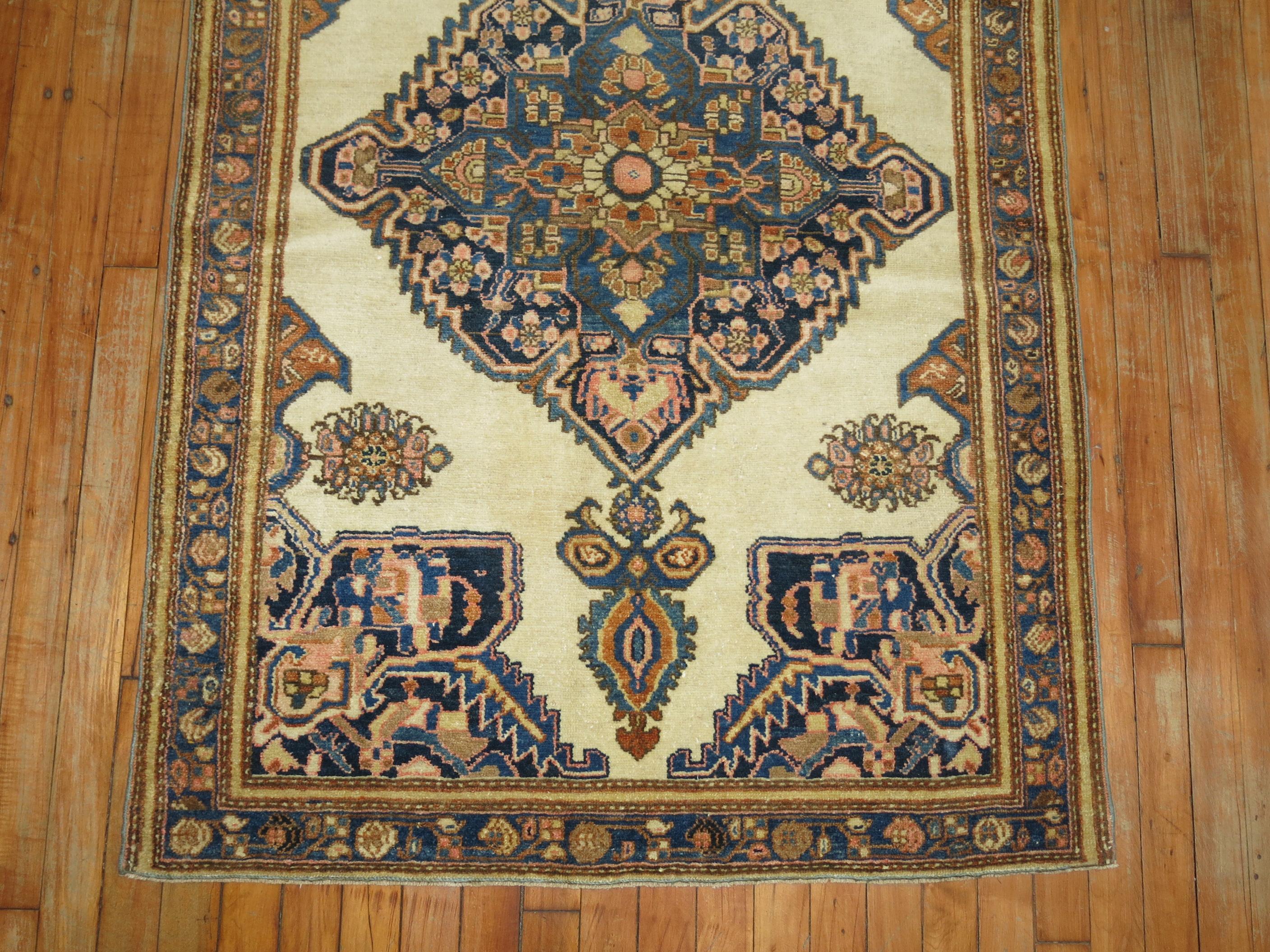 Authentic Persian Ferehan throw rug with an ivory field.

3'3'' x 5'1''