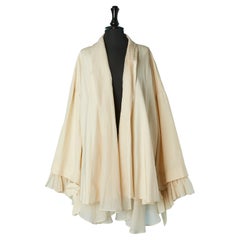 Ivory raw silk A-line coat with silk ruffles on the sleeve edge Dice Kayek