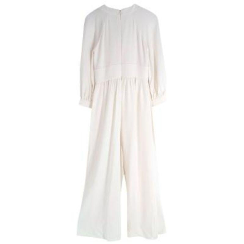 Christian Dior ivory silk crepe keyhole neck jumpsuit
 
 - Elegant, and minimal cut, featuring a high neck, with keyhole cut-out, long balloon sleeves, and fluid wide legs
 - Midweight silk crepe de chine with good drape 
 - Concealed zip back
 -