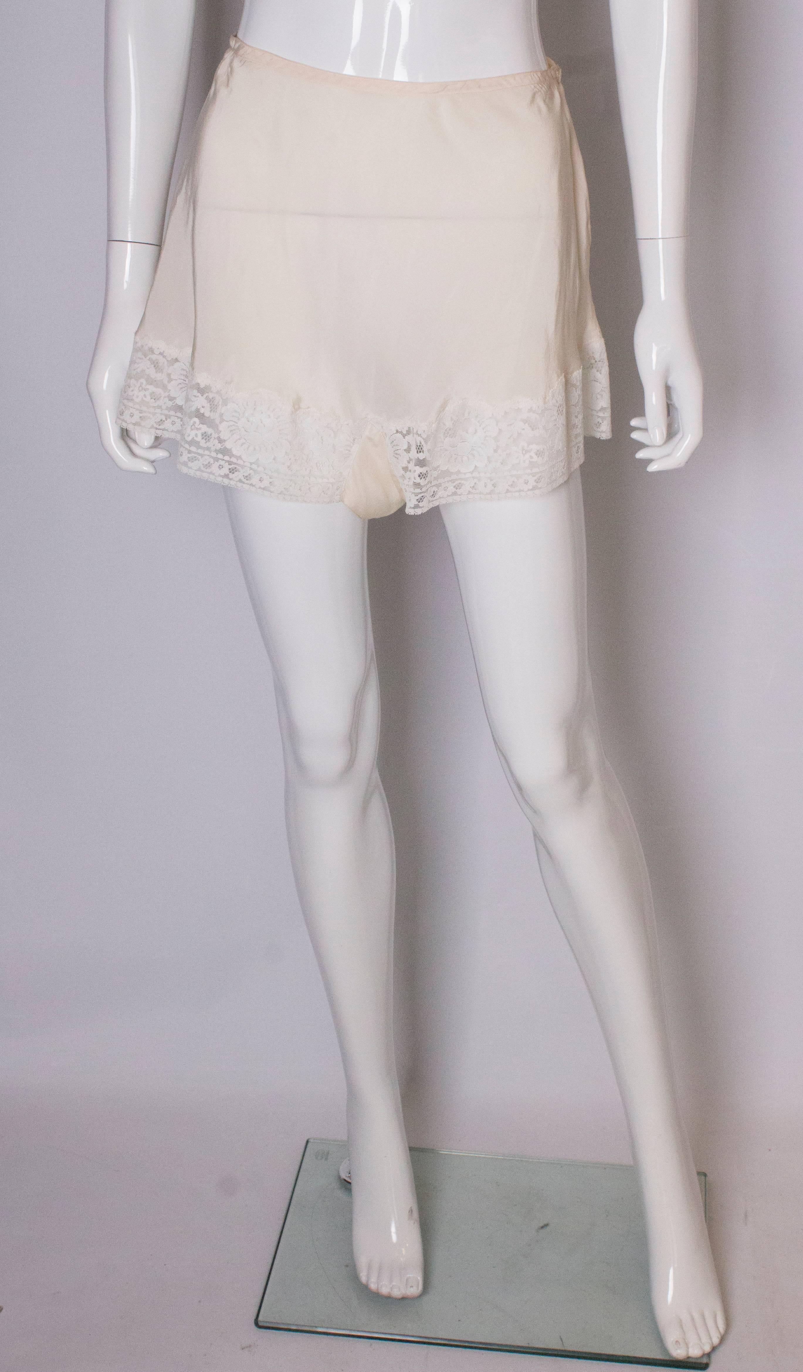 A chic pair of ivory silk pants/shorts by Unique. They are marked size 36 and have a lace tri.