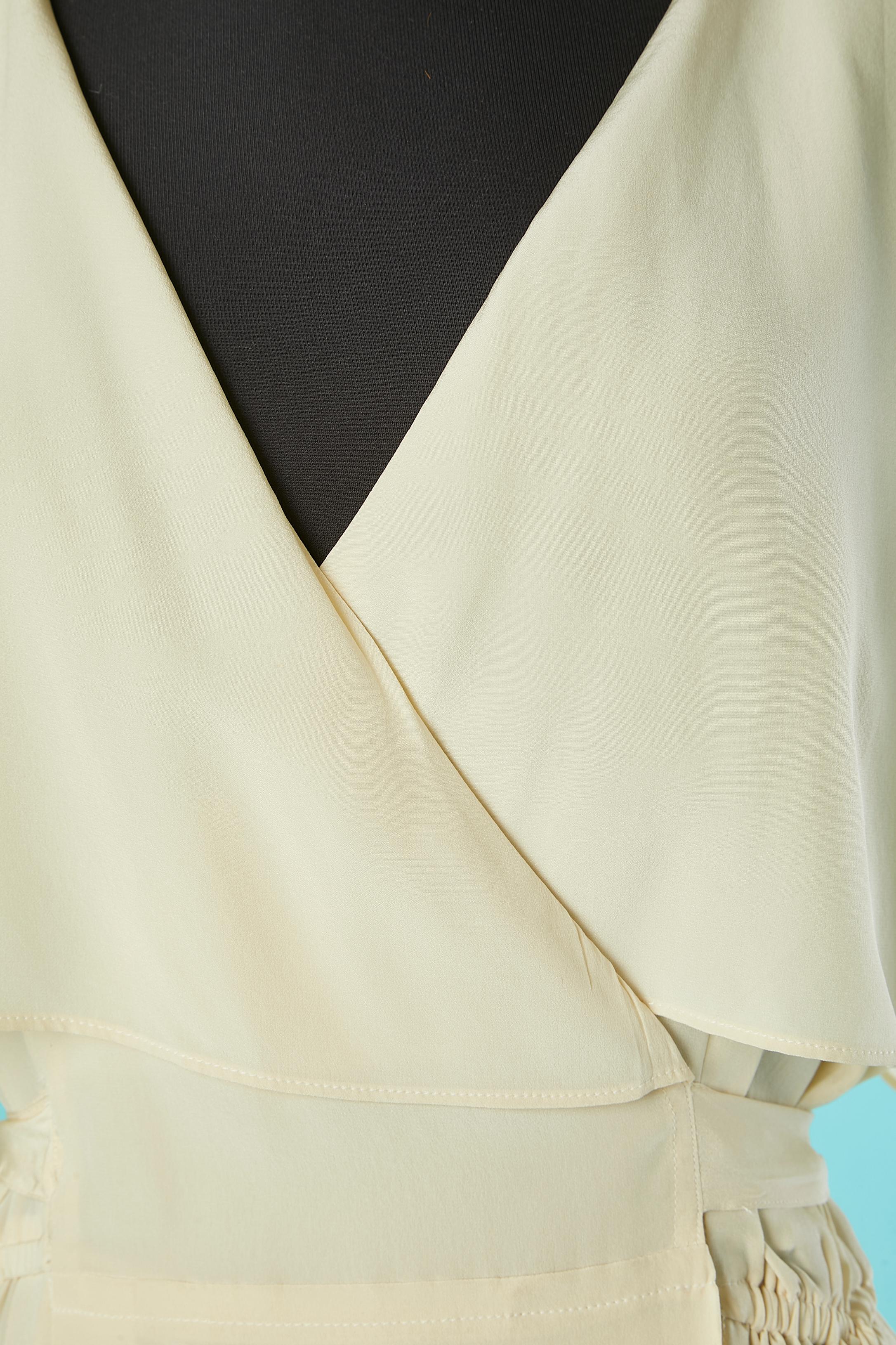 Ivory silk wrap dress . Pocket on both side. Shoulder-pad. Elastic waist band. Collar. Split on both side, lenght = 30 cm 
Adjustable waist. 
SIZE 38 (Fr) M 