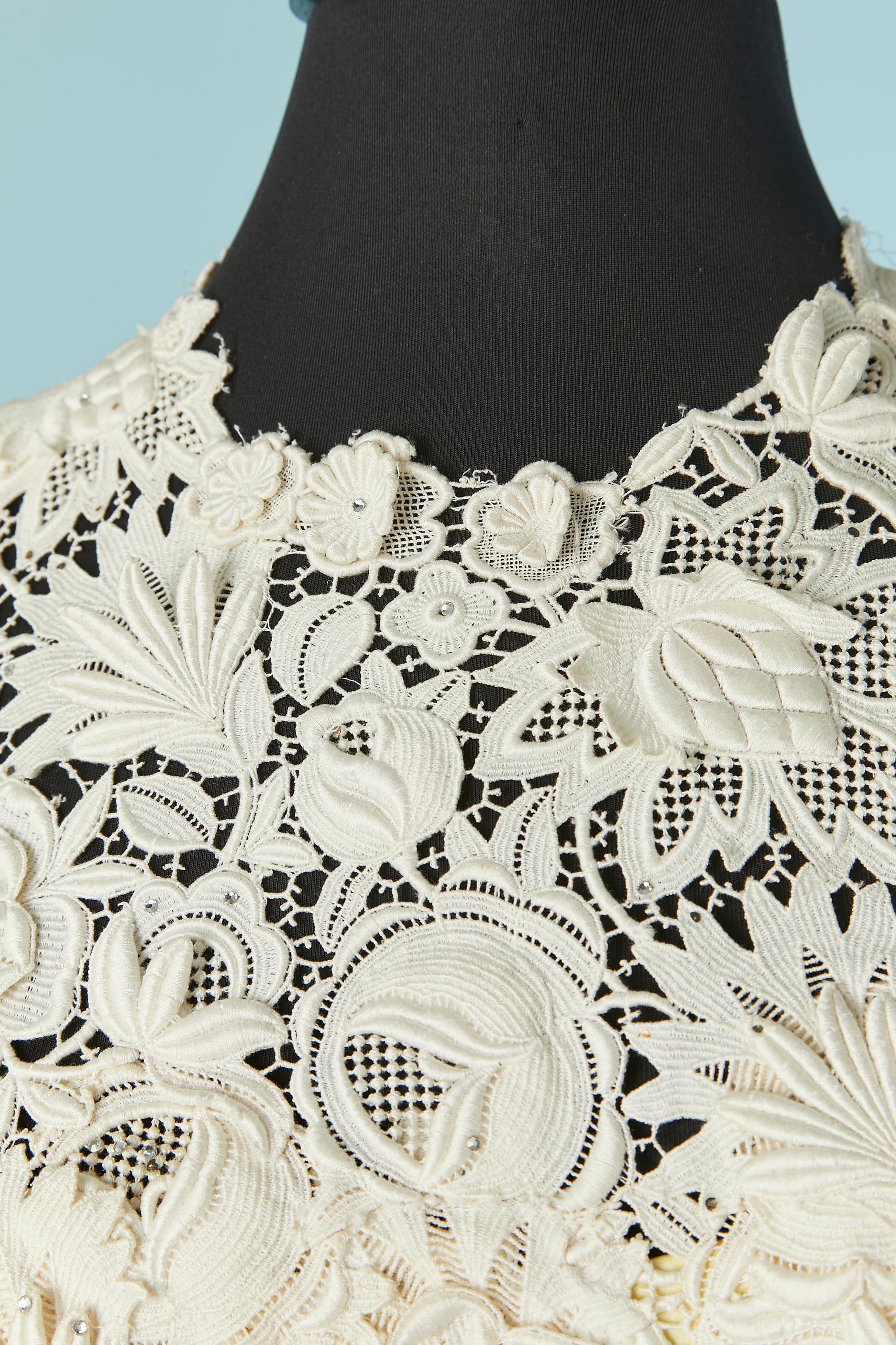 Ivory sleeveless cotton guipure dress with rhinestone embellishment. Yellow silk lining. Zip, snap and hook&eye closure on the middle back. Boned bustier inside. 
SIZE S 