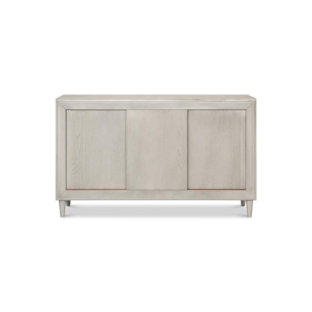 If you're looking for a stylish and versatile piece to elevate your dining or living space, look no further than the Ivory Sliding Door Buffet. Made with poplar and chestnut veneer, this buffet boasts a beautiful ivory contemporary finish that will