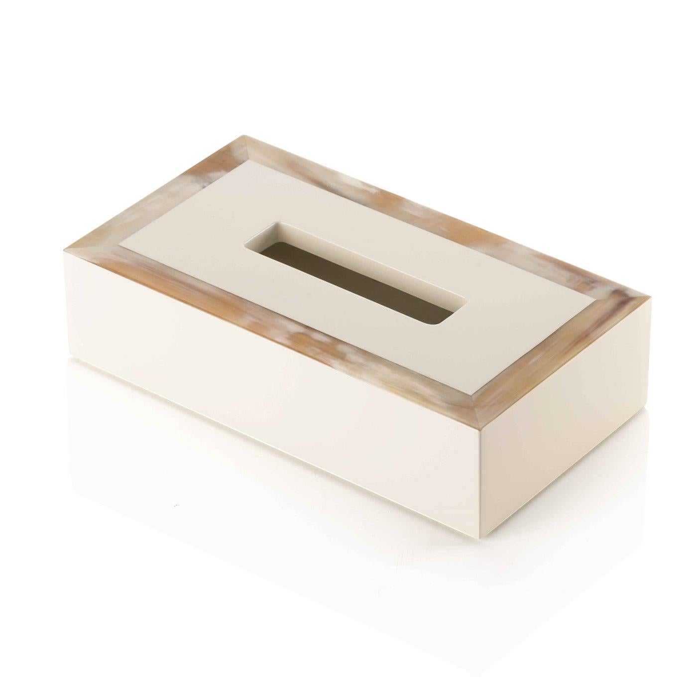 This eye-catching tissue box holder captures the elegance of restrained lines merging it with plush materials. Its prized structure in wood and horn is completed by a lacquered, ivory and polished finish, that makes it an outstanding piece of decor.