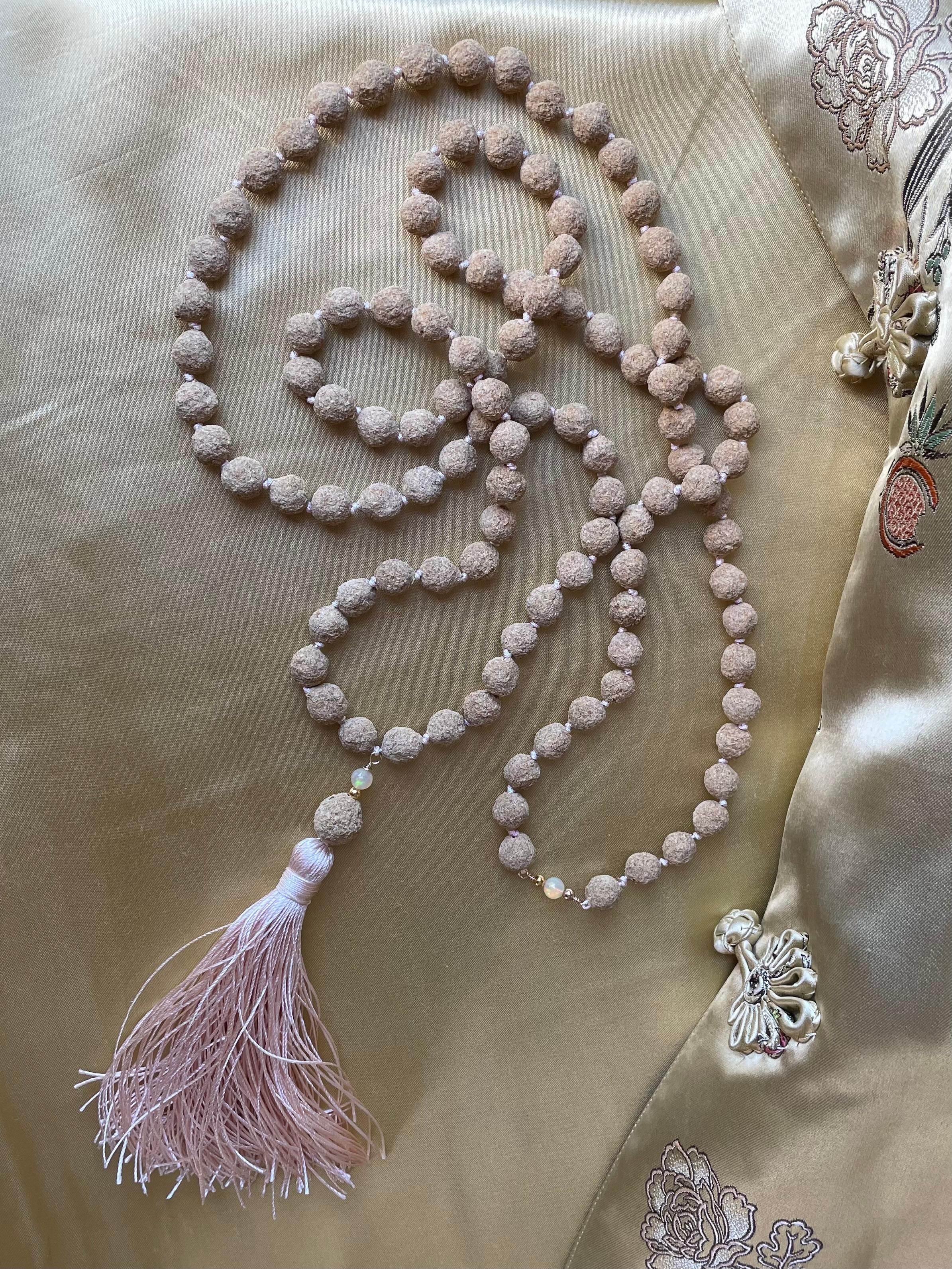 In the quiet space where craftsmanship meets intuition, I have woven together something truly special for you. This hand-knotted 108-rose petal mala, a delicate interplay between the earthly elegance of Vendela Ivory Roses and the celestial glow of