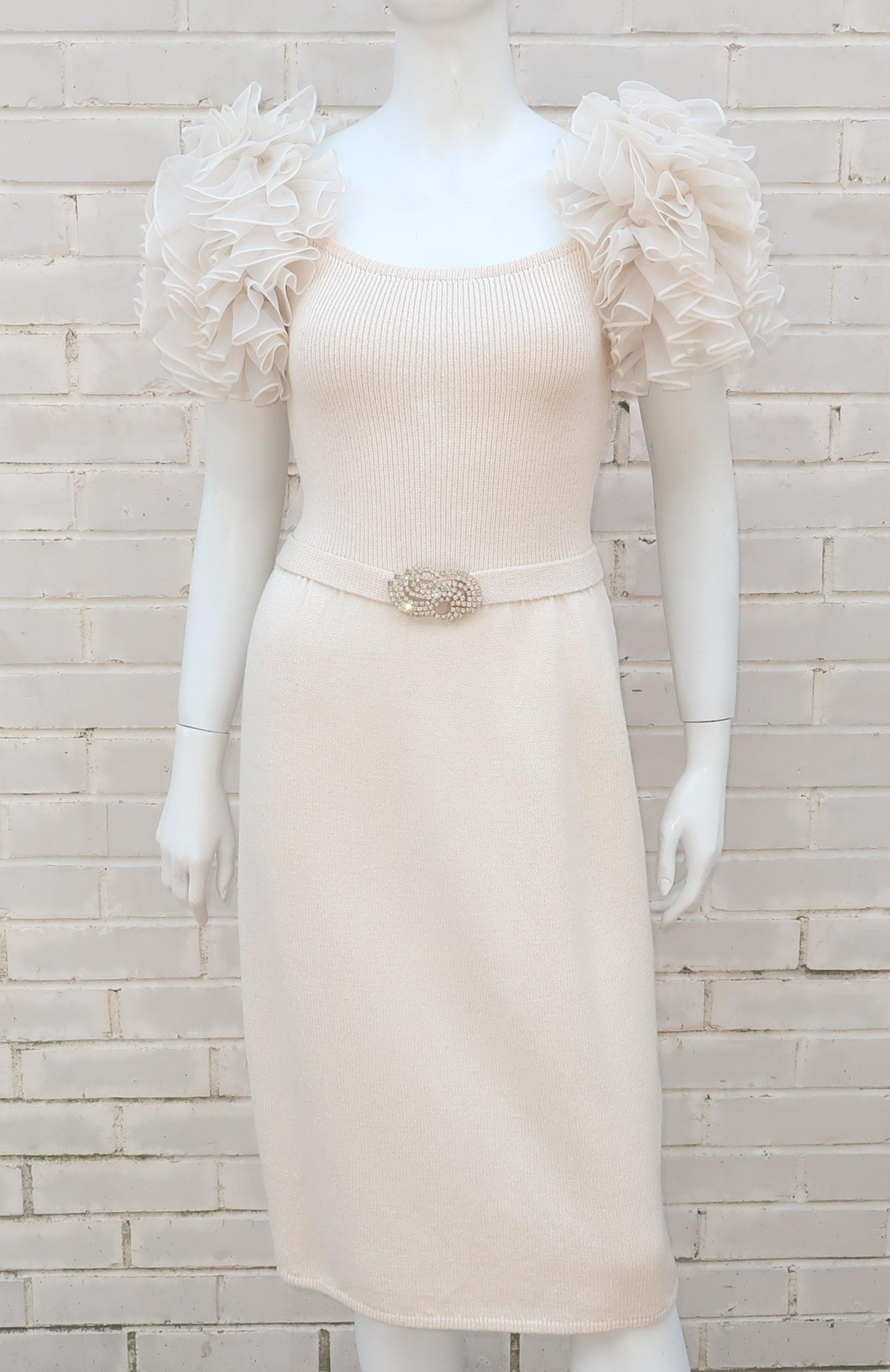 Ultra feminine C.1980 St. John ivory white knit dress with organza ruffled puff sleeves and a coordinating belt embellished with a rhinestone buckle.  The design elements that women love about St. John are present and accounted for, including the