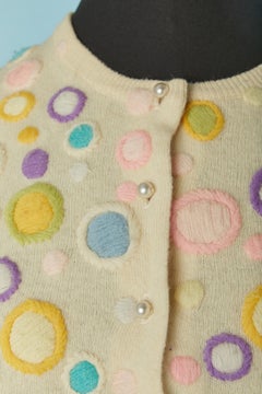 Ivory wool cardigan with hand decorated pattern on Gene SHELLY'S