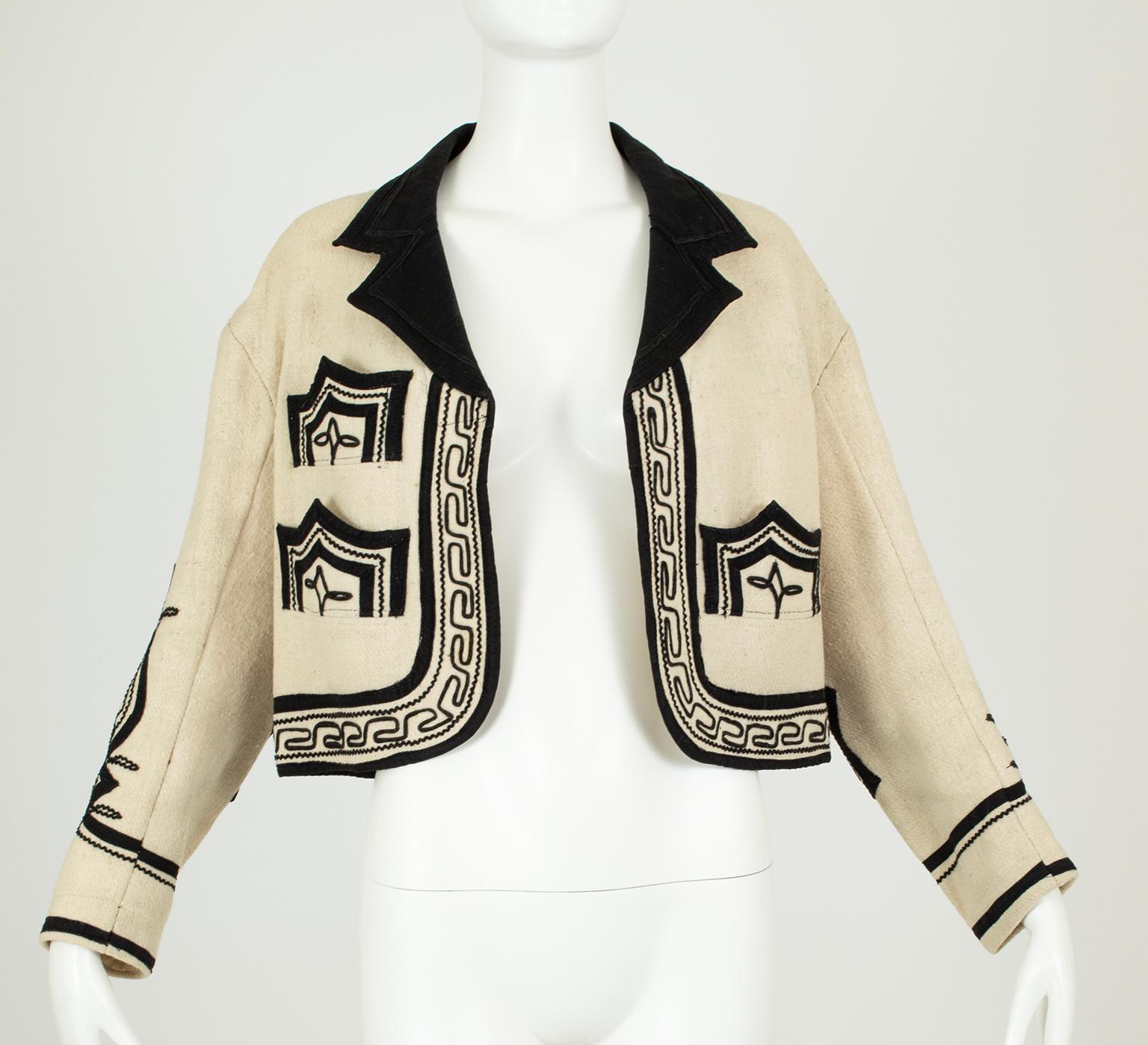 Purchased in a Guatemalan market in 1971, this magnificent jacket is an artisanal example of folk costume down to its pockets lined in vintage flour sack. Striking and symmetrical, it is the focal point of any ensemble.

Cropped Guatemalan jacket of