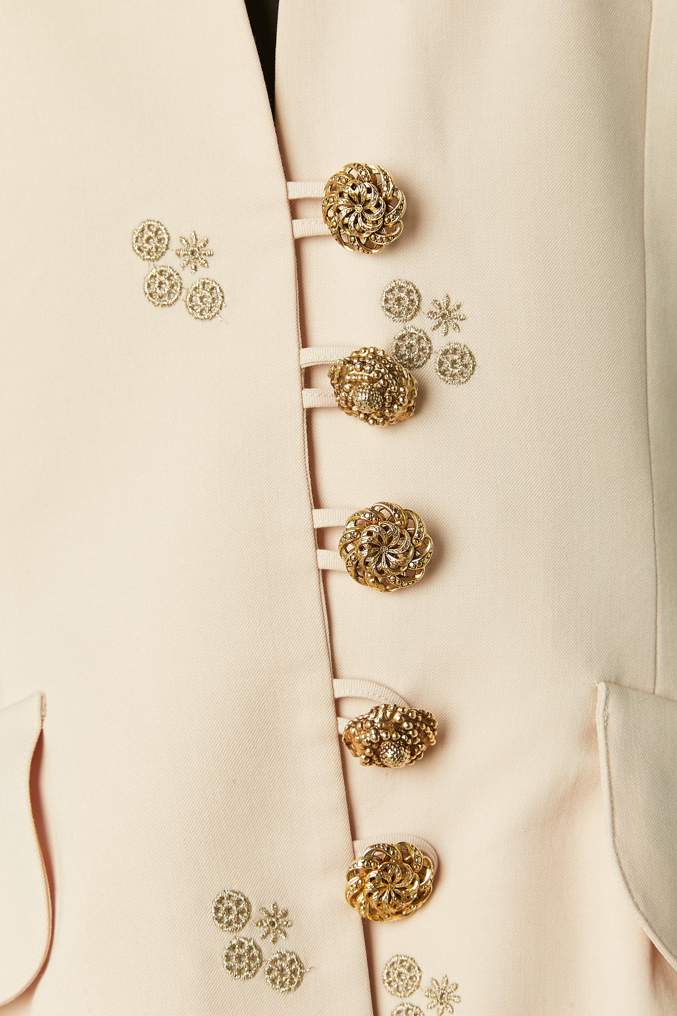 Ivory wool skirt suit with gold threads embroideries and jewellery buttons. No fabric composition tag for the lining but probably acetate or rayon. 
Shoulder pad. Pockets on both side on the jacket. 
SIZE 38 (Fr) M 