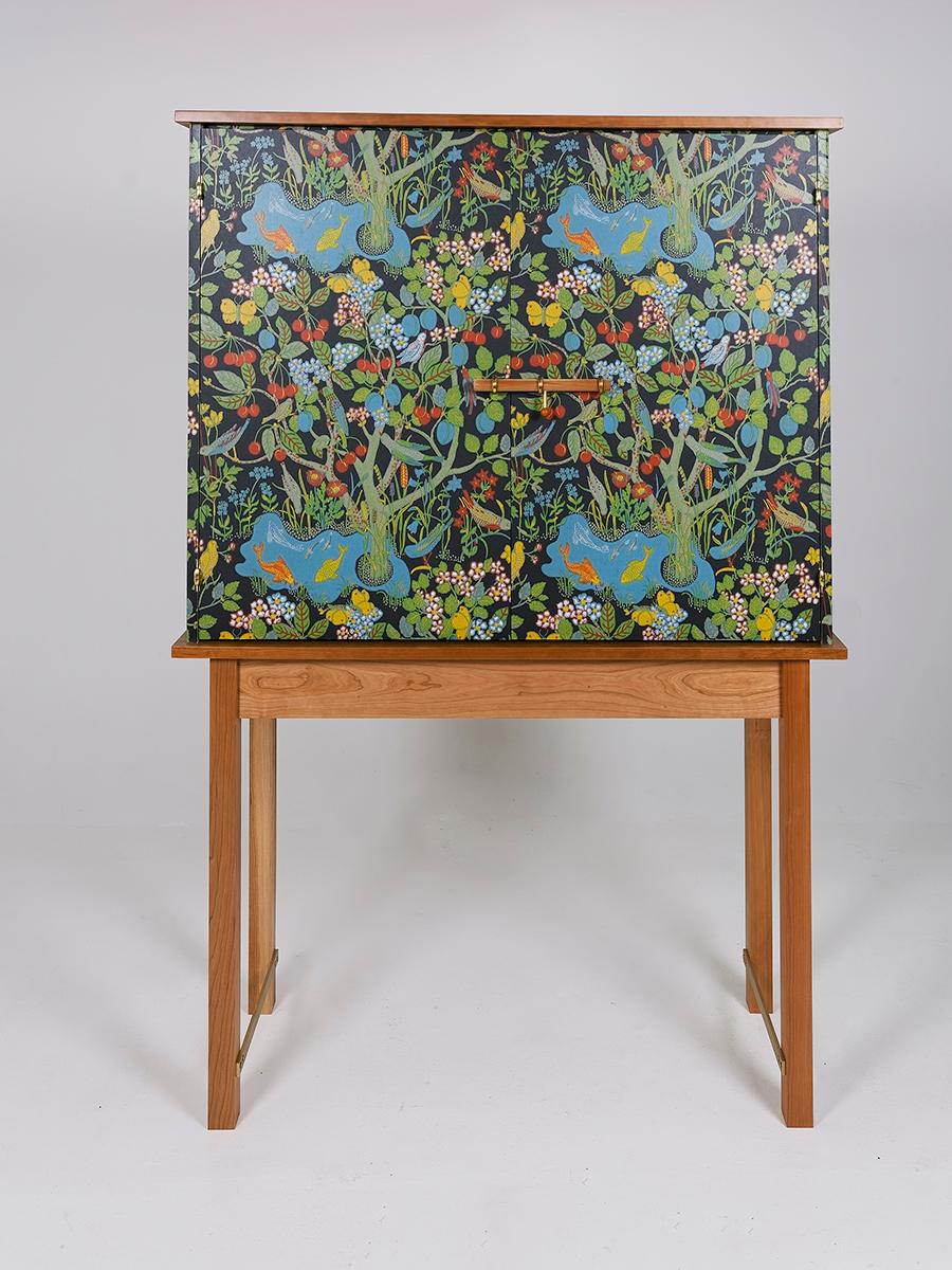 IVY Cabinet by Dosbananos. Two-door cabinet covered in original Josef Frank 'Paradiset' wallpaper. Cherry wood with brass hinges and brass stretchers. Cabinet has four adjustable shelves and a unique brass cherry dowel lock. Ready for a new home.