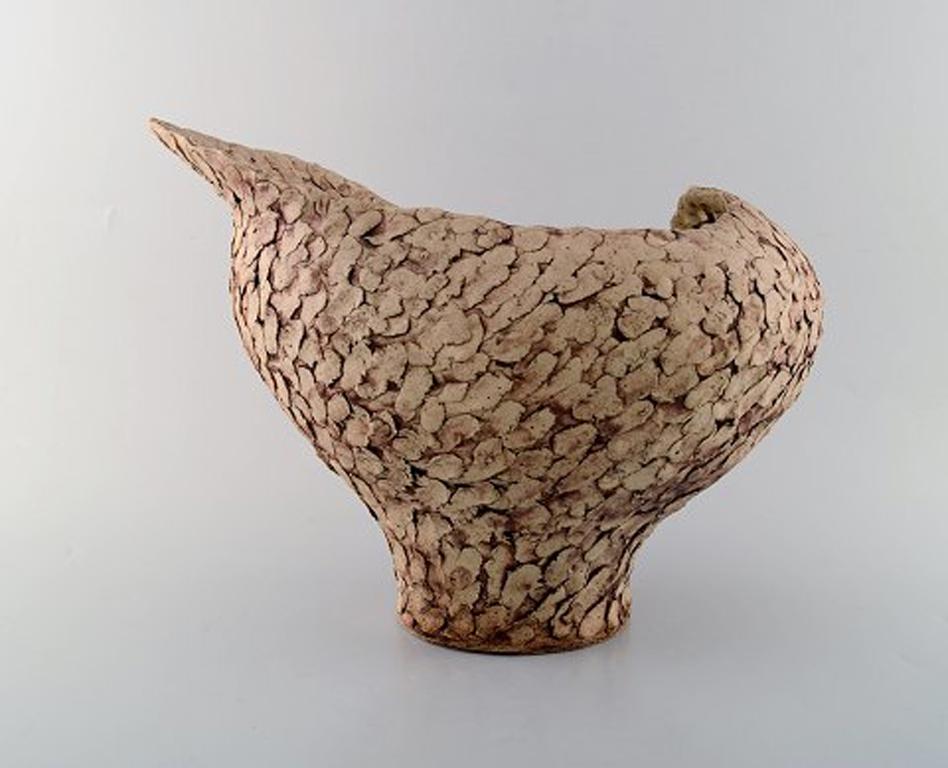 Ivy Lysdal, b. 1937. Danish ceramist and painter.
Large unique vase in organic shape. glaze in earth tones. 1970s.
In very good condition.
Measures: 35 x 25,5 cm
Signed.

Educated at the arts and craft school in Copenhagen (1954-57).
Employed