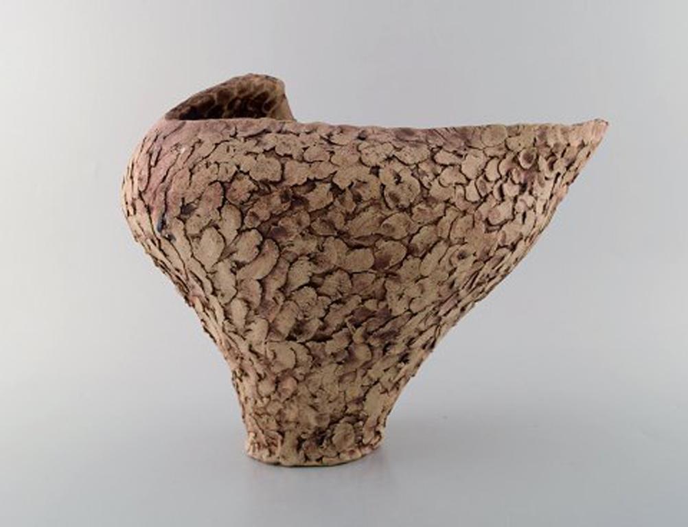 Ivy Lysdal, b. 1937. Danish ceramist and painter.
Large unique vase in organic shape. Glaze in earth tones, 1970s.
In very good condition.
Measures: 34 x 26.5 cm
Signed.

Educated at the arts and Craft school in Copenhagen