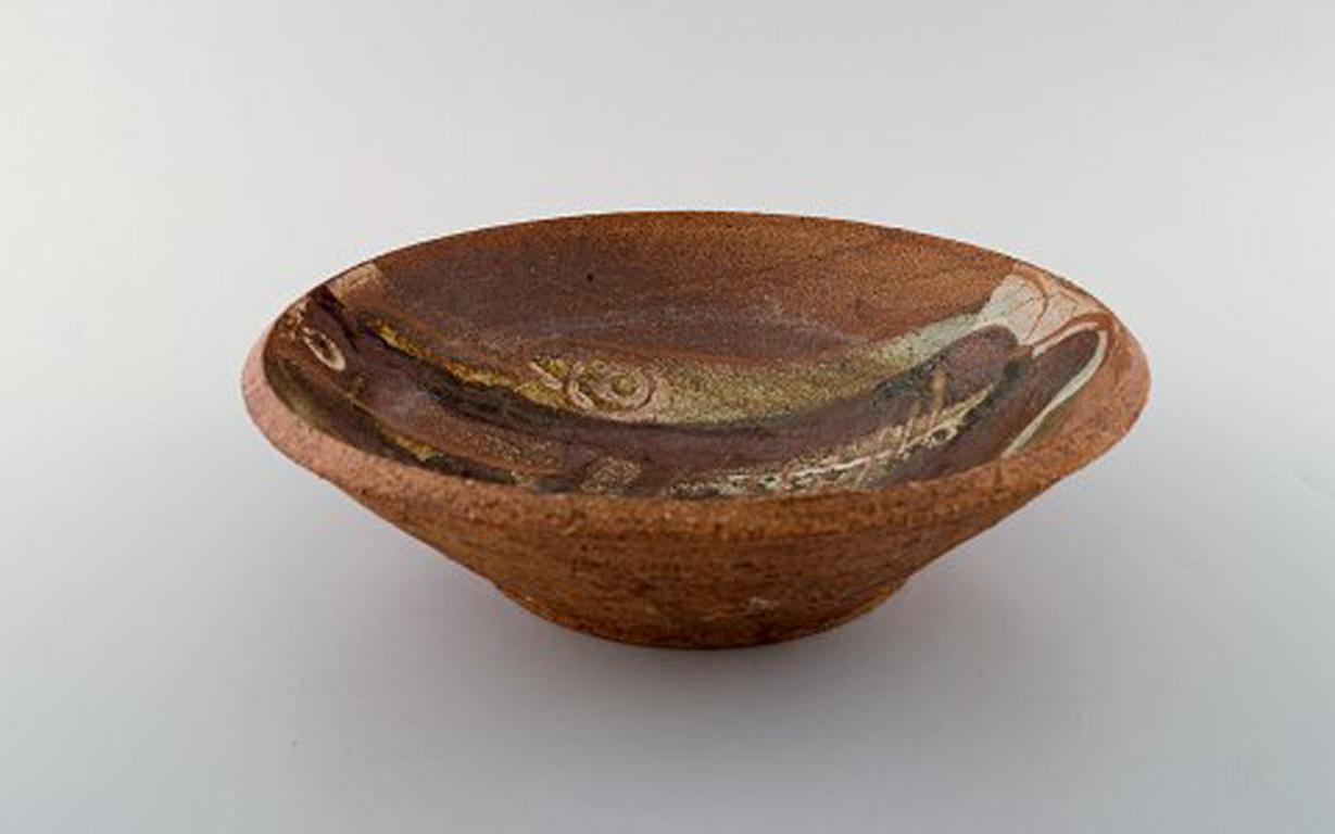Ivy Lysdal, b. 1937. Danish ceramist and painter.
Unique bowl in glazed ceramics with fish motif. 1970's.
In very good condition.
Measures: 25 x 7 cm
Signed: Lysdal-Flint.

Educated at the arts and craft school in Copenhagen