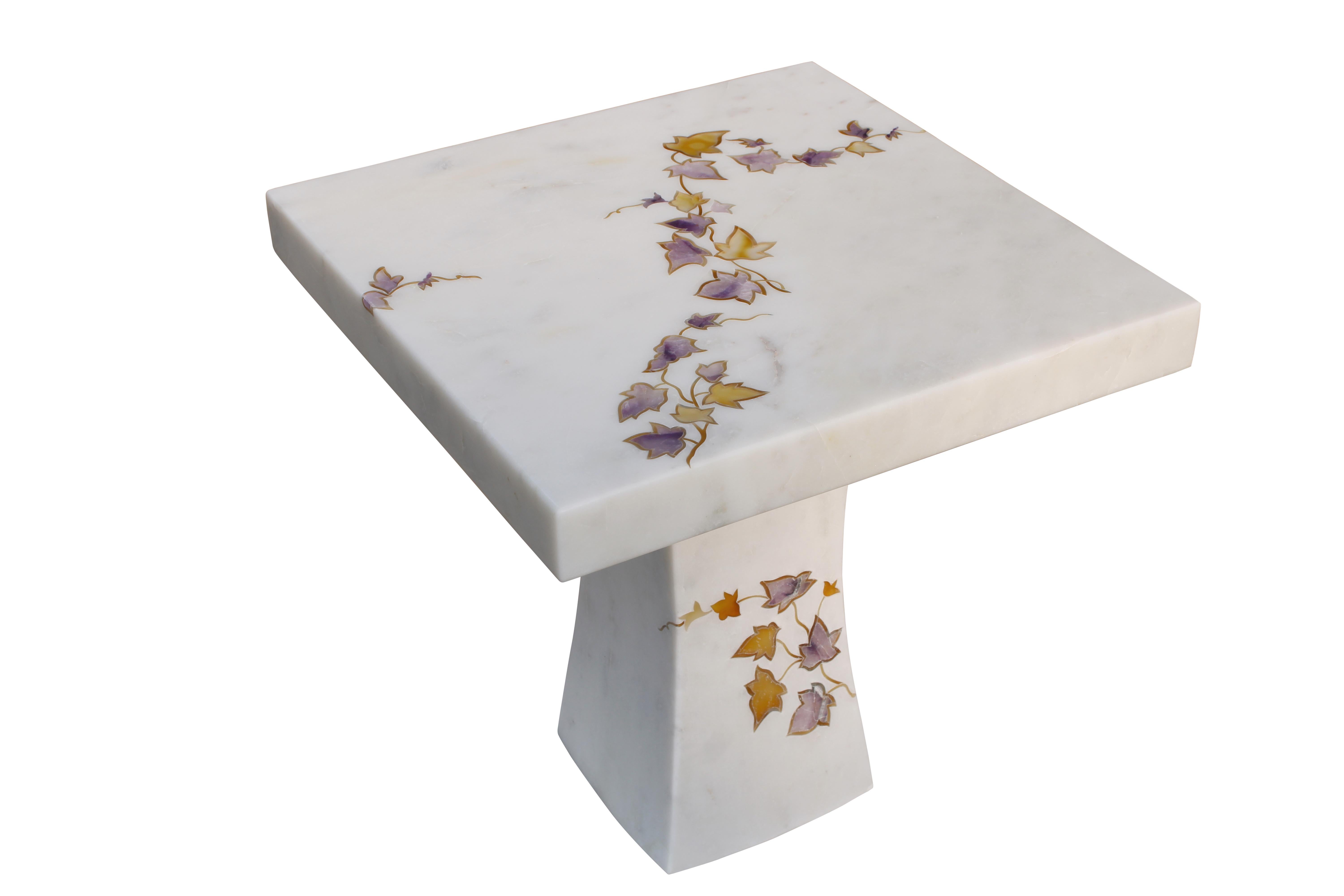 The Ivy table is a part of the Ornamenti collection. Delicately cut pieces of agate, tiger eyes, mother of pearl and other semi precious stones are carefully inlaid into the base stone by our master craftsmen. The collection features modern designs