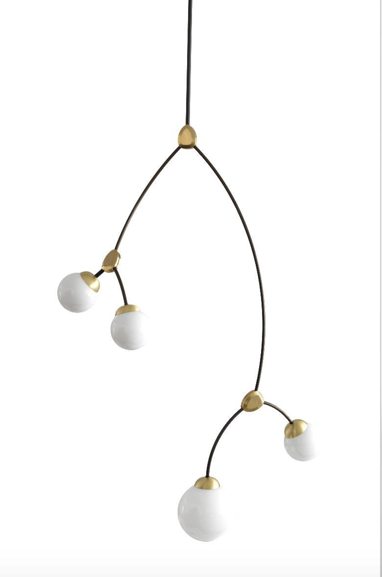 Ivy vertical 4 lamp by CTO lighting.
Materials: bronze with satin brass details and opal glass shades (also available in smoked glass).
Dimensions: H 125 x W 75 cm.

All our lamps can be wired according to each country. If sold to the USA it will be