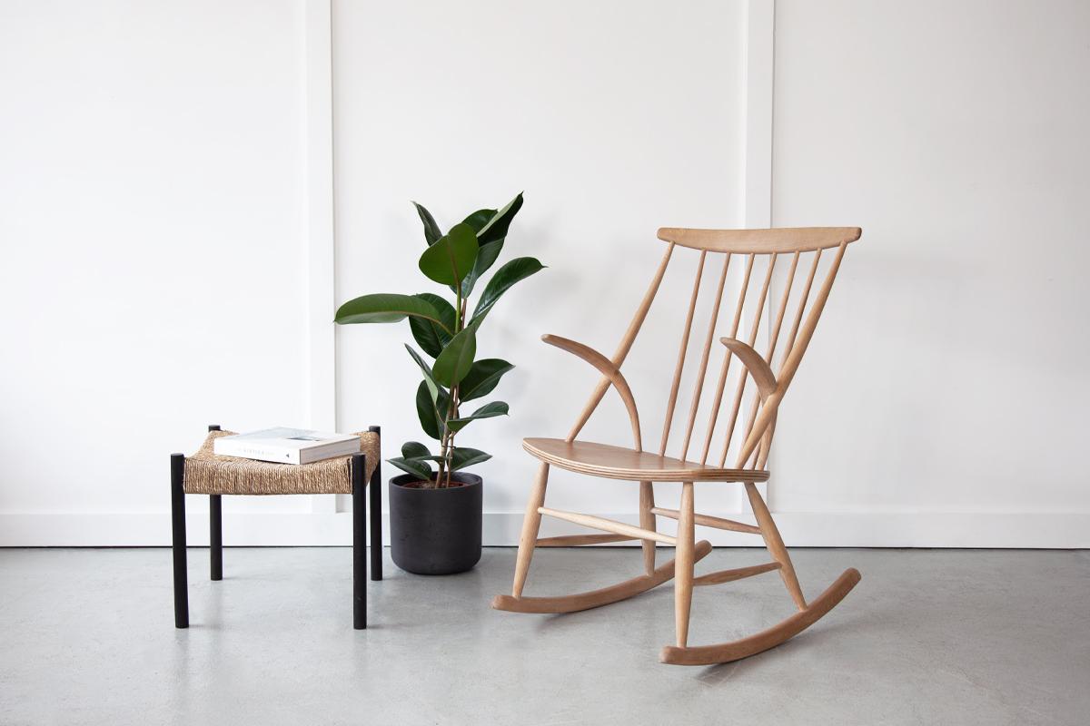 The beautiful 'IW3' rocking chair by Illum Wikkelsø for Niels Eilersen, in beech wood with a high back and iconic armrests.