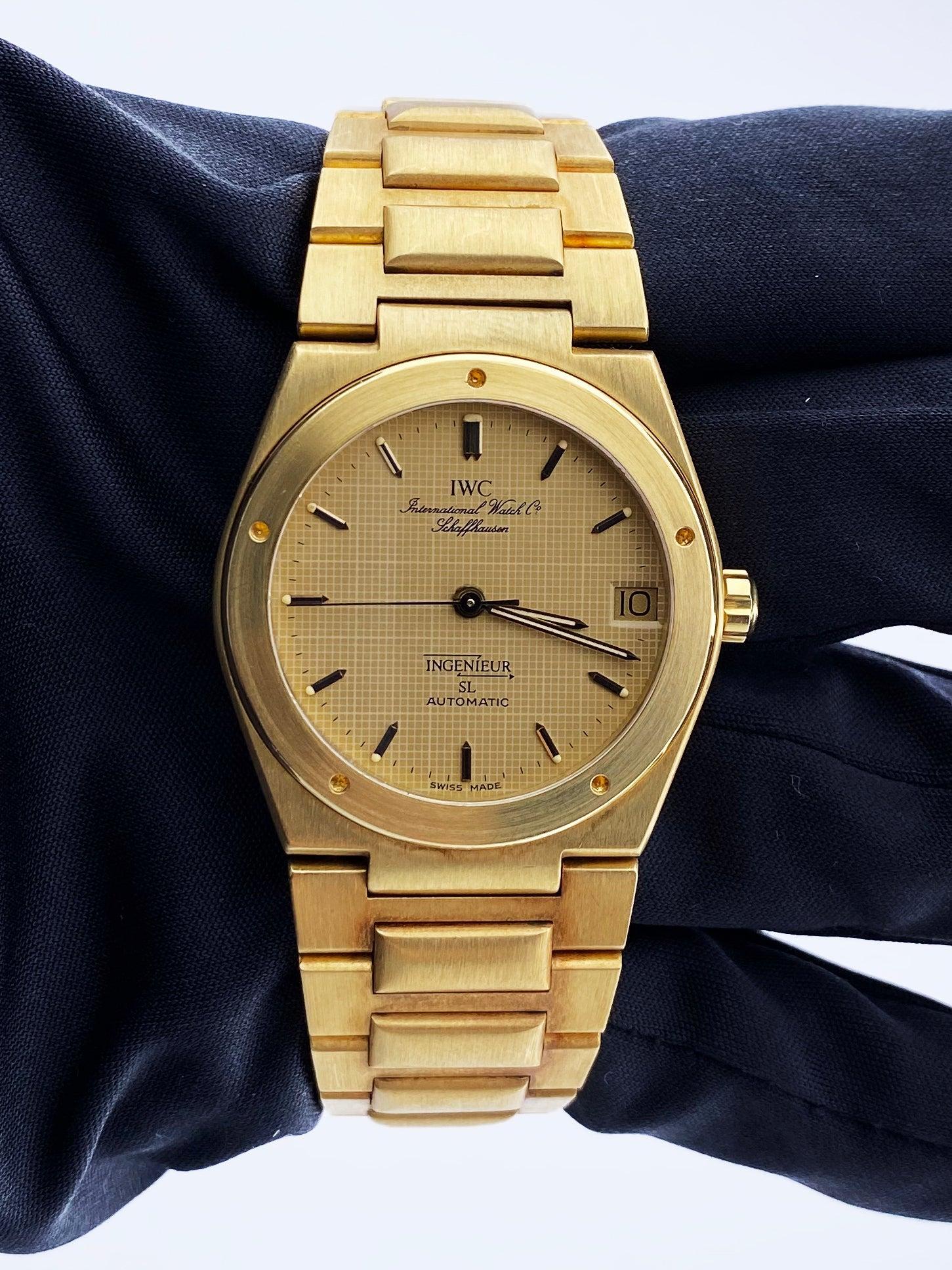 IWC Ingenieur 9230 Mens Watch. 34mm 18k yellow gold case. 18k yellow gold bezel. Champagne dial with luminous gold hands and index hour markers. Minute markers on the outer dial. Date display at the 3 o'clock position. 18k yellow gold bracelet with
