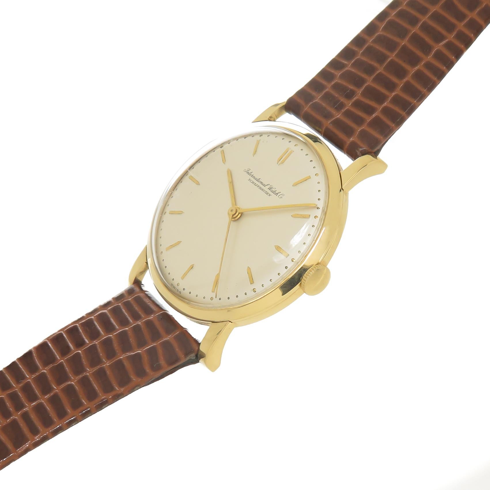 Circa 1960 IWC International Watch Company Schaffhausen Wrist Watch, 33 MM 18K Yellow Gold 2 Piece case. 17 Jewel Mechanical, manual wind Nickle lever movement. Original Beautiful mint condition Silvered dial with Raised Gold markers and a Sweep