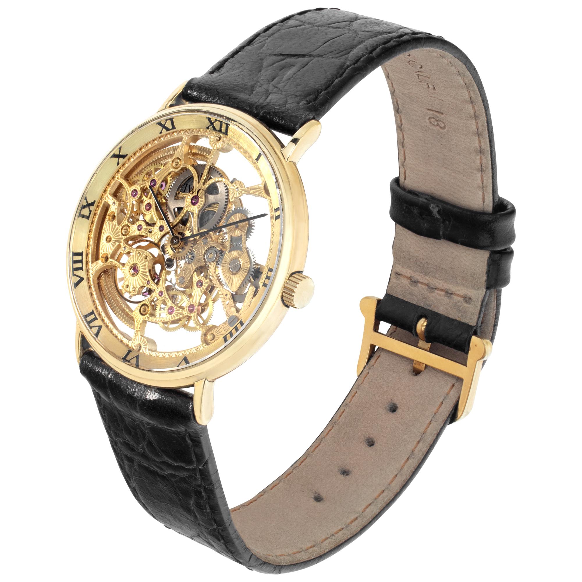 IWC Portofino Skeleton in 18k yellow gold on a black crocodile strap with an original IWC tang buckle. Automatic movement with IWC caliber C 271.7 engraved and skeletonized with 34 jewels. 33 mm case size. Circa 1990s. Ref 2701. Fine Pre-owned IWC