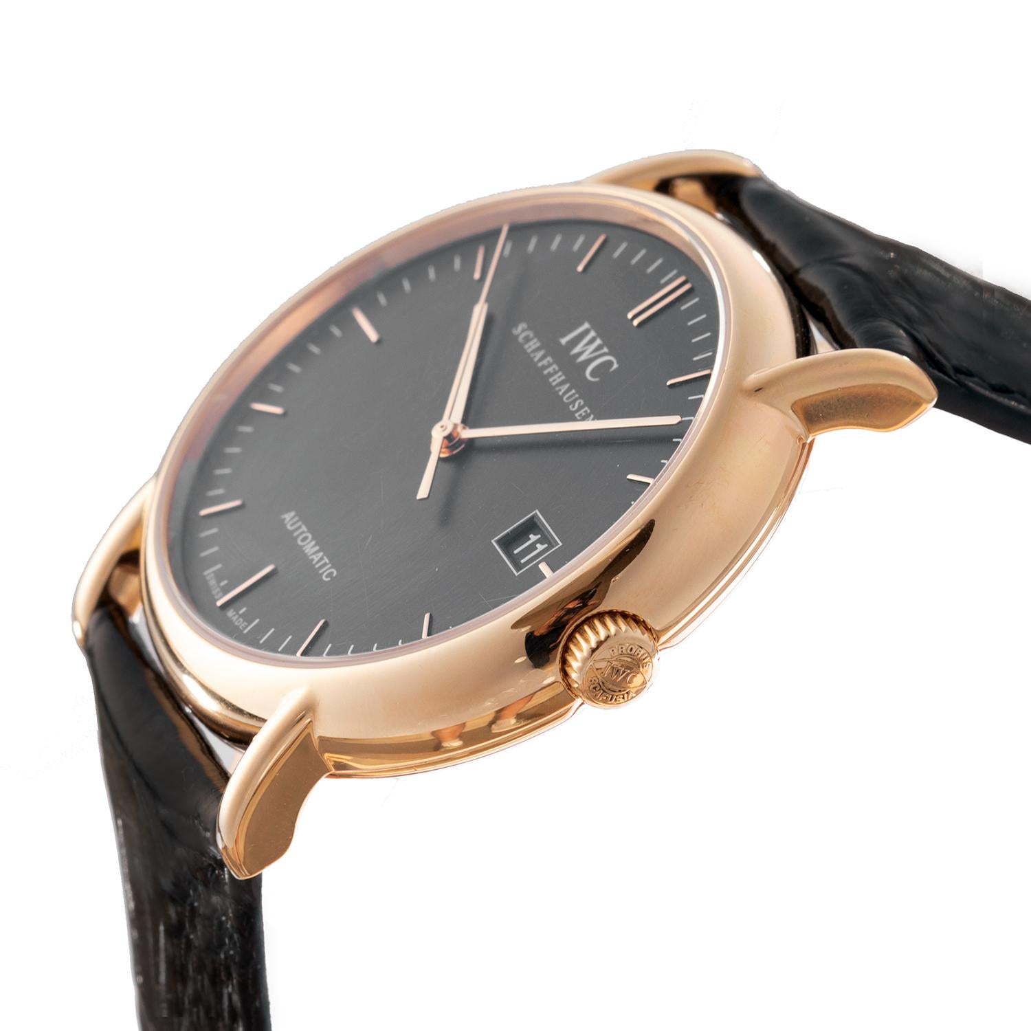 Pre-owned IWC Portofino Automatic wristwatch (ref. IW353320), featuring a self-winding automatic movement; black dial with date display at 3 o'clock; and 38mm, 18k rose gold case on a black alligator leather strap secured by an IWC 18k rose gold