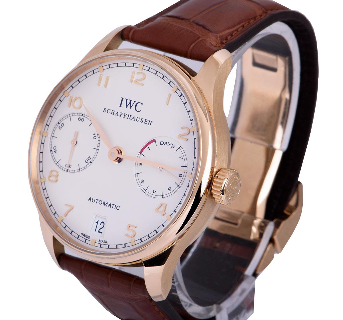 A 42.3 mm 18k Rose Gold Portuguese 7 Day Gents Wristwatch, silver dial with applied arabic numbers, 7 day power reserve indicator at 3 0'clock, date at 6 0'clock, small seconds at 9 0'clock, a fixed 18k rose gold bezel, an original brown leather
